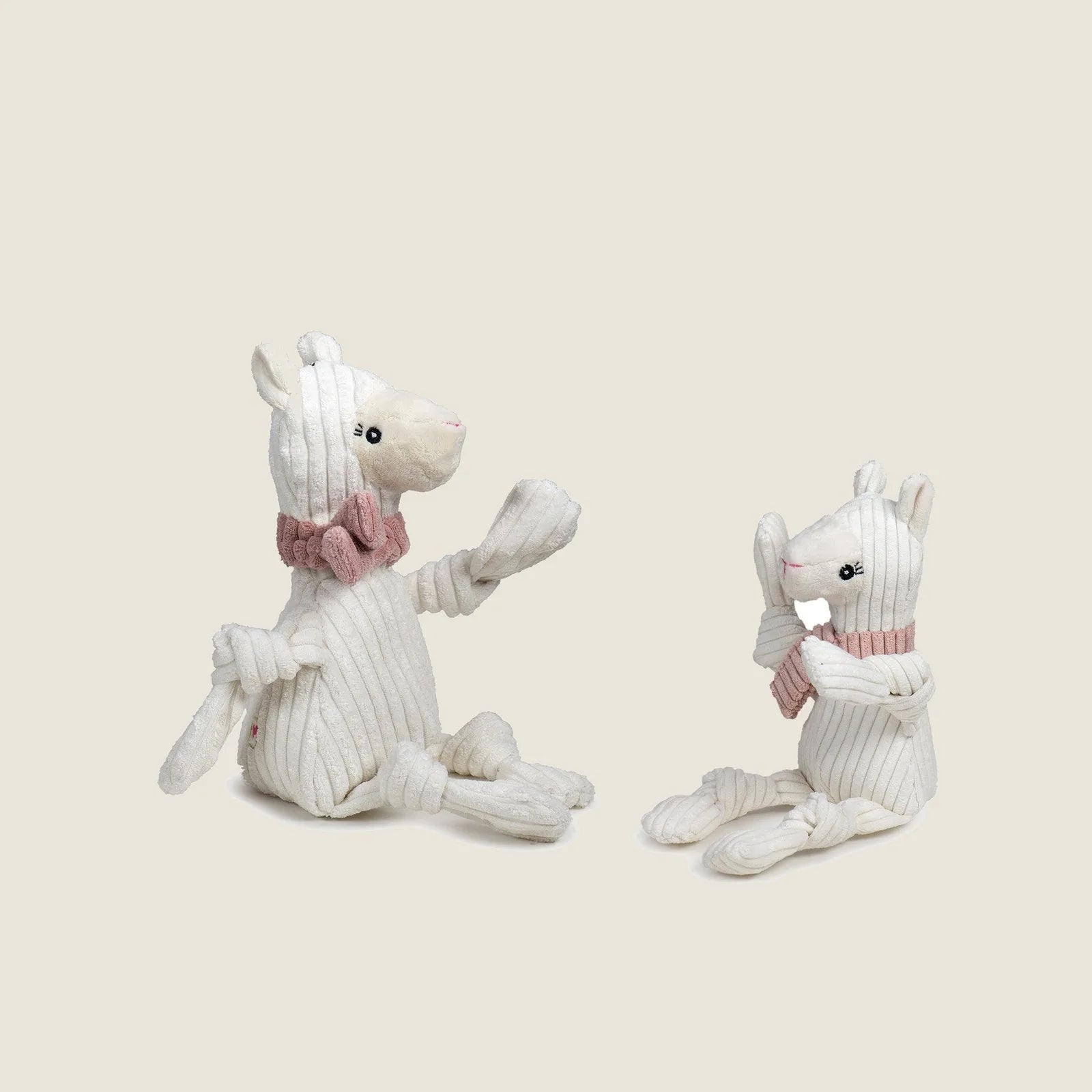 Lillie Llama Knottie® plush dog toy with banana-shaped ears and pink scarf, perfect for cuddles and playtime.
