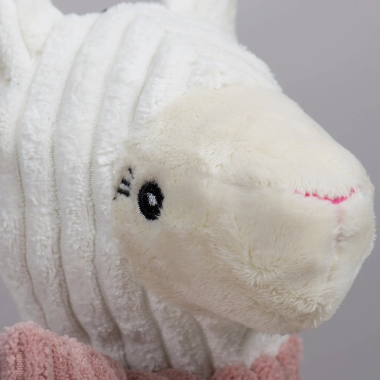 Lillie Llama Knottie® plush dog toy features a soft cream-colored body with a pink scarf and detailed facial features.