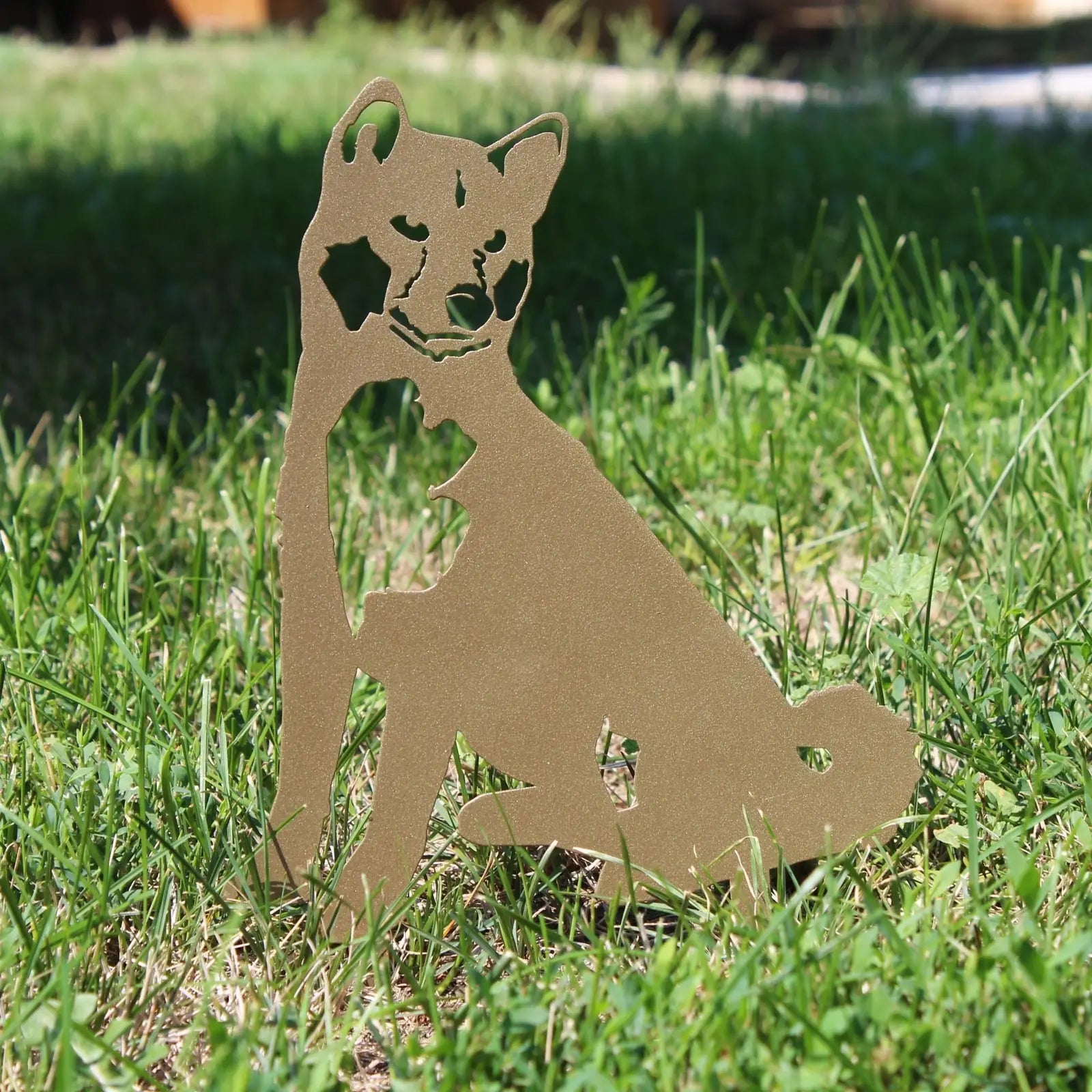 Limited Edition gold Shiba Inu metal silhouette sitting on grass, made from weathering steel with a sleek design.