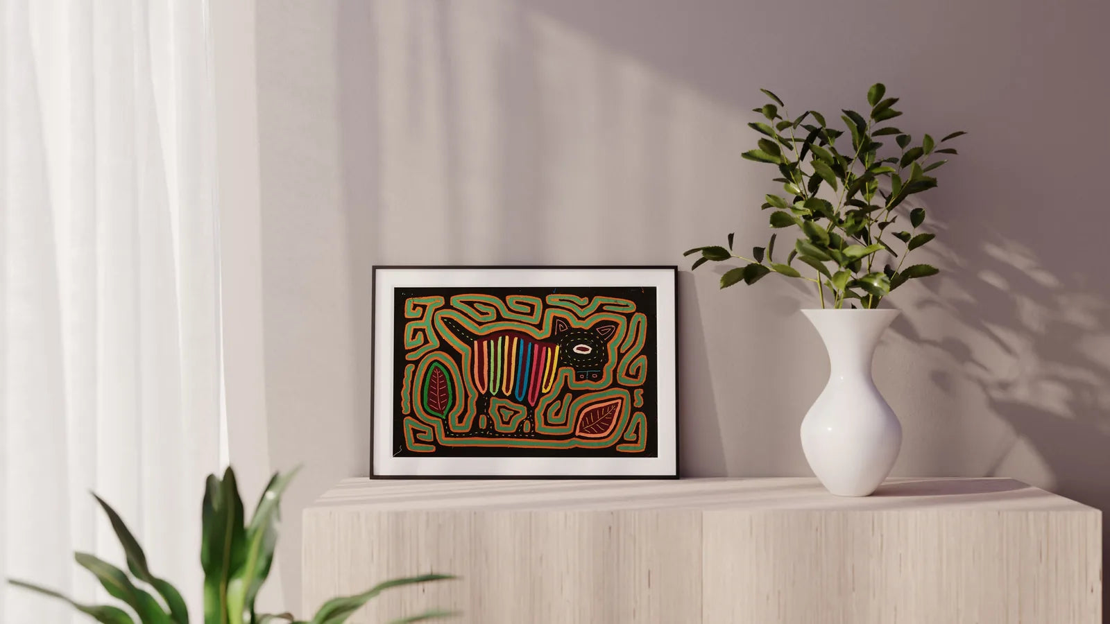 Colorful hand-stitched Mola depicting a puppy with geometric patterns, framed and displayed on a light wooden surface.