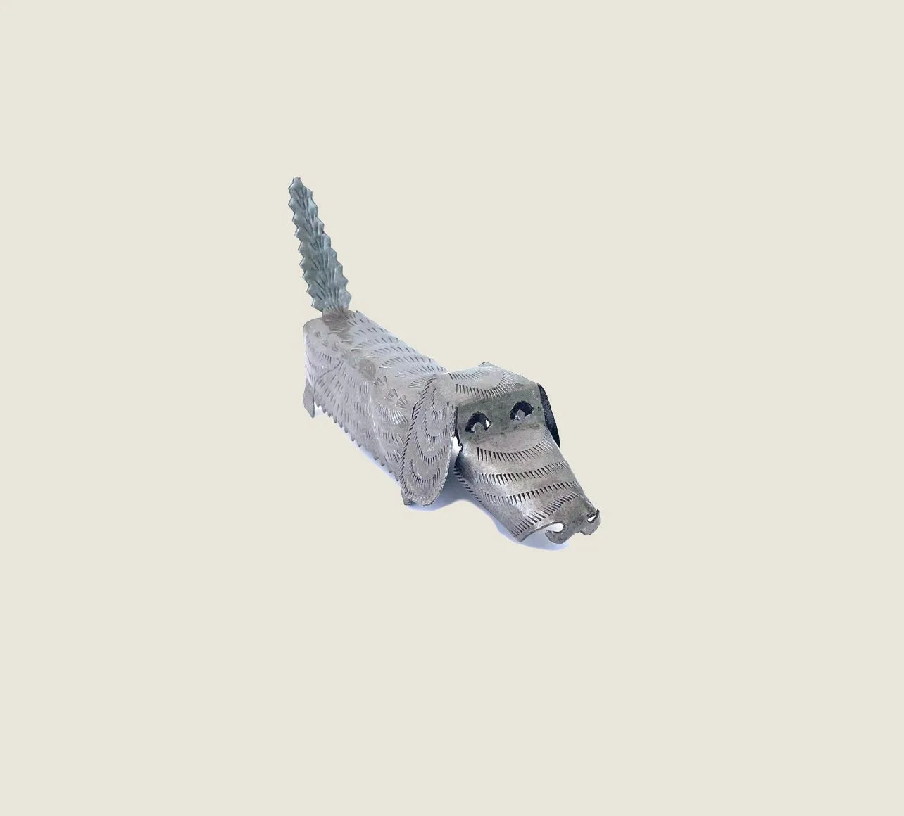 Handcrafted metal art dog sculpture in silver, showcasing unique patterns, tail, and facial features, celebrating Haitian...