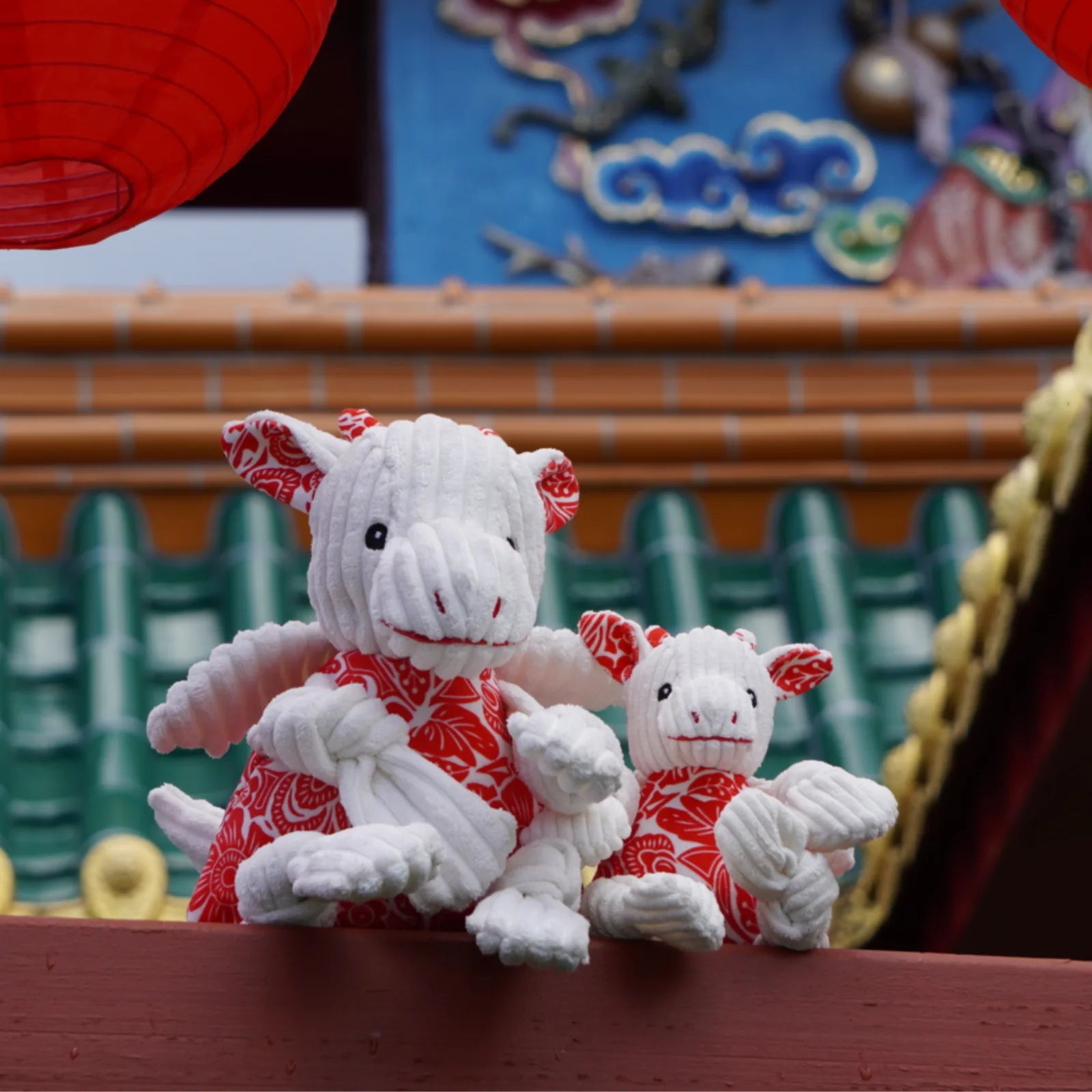 Plush Lucky Dragon Knottie® dog toys in red and white with soft corduroy, showcasing zodiac-inspired patterns.