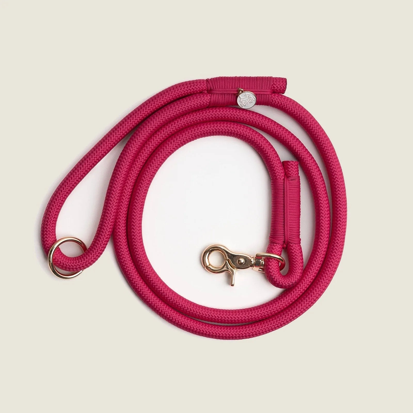Magenta braided rope leash with gold clip, featuring a comfortable handle and an O-ring for accessories.