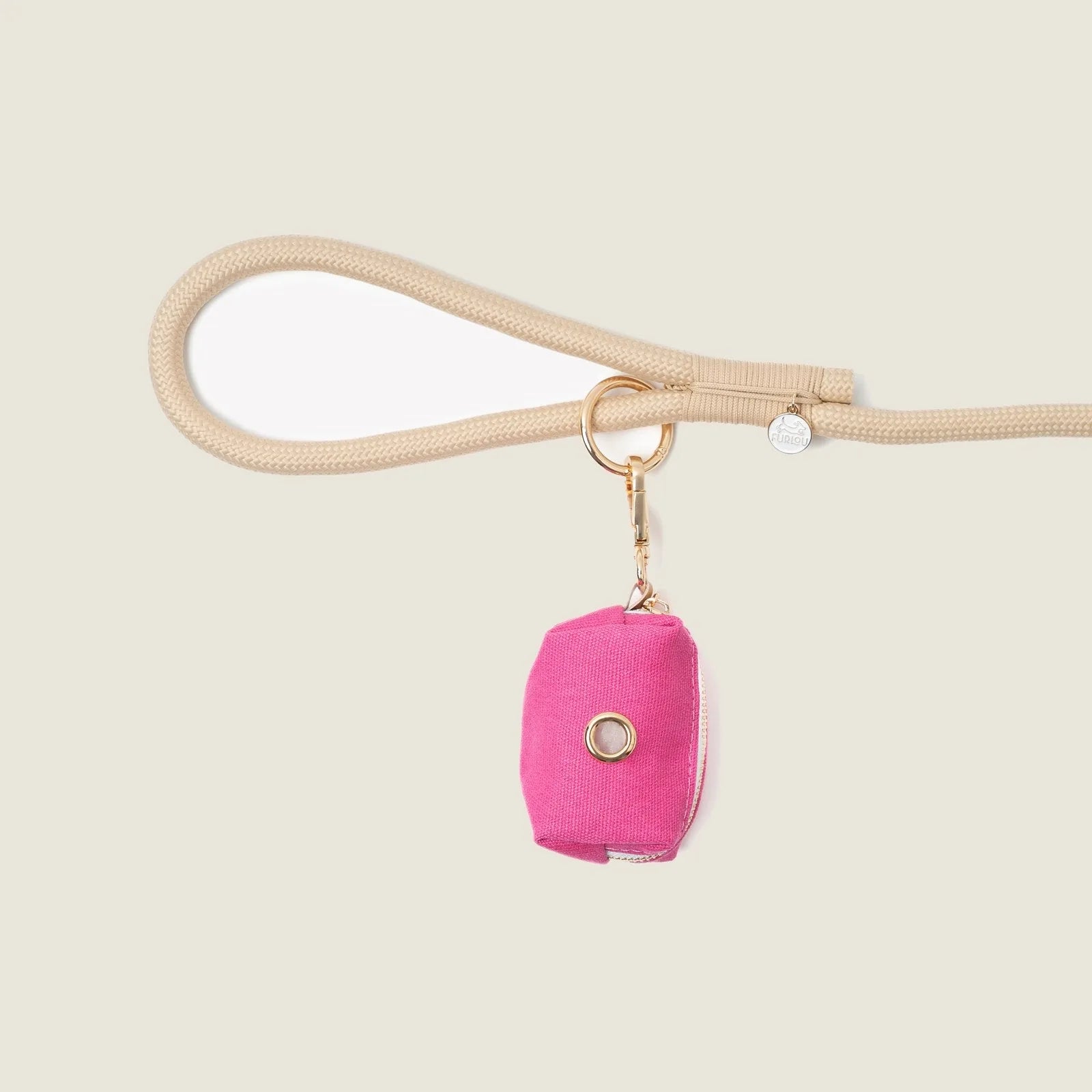 Magenta poop bag holder by FURLOU attached to a beige leash, showcasing a compact, stylish design.