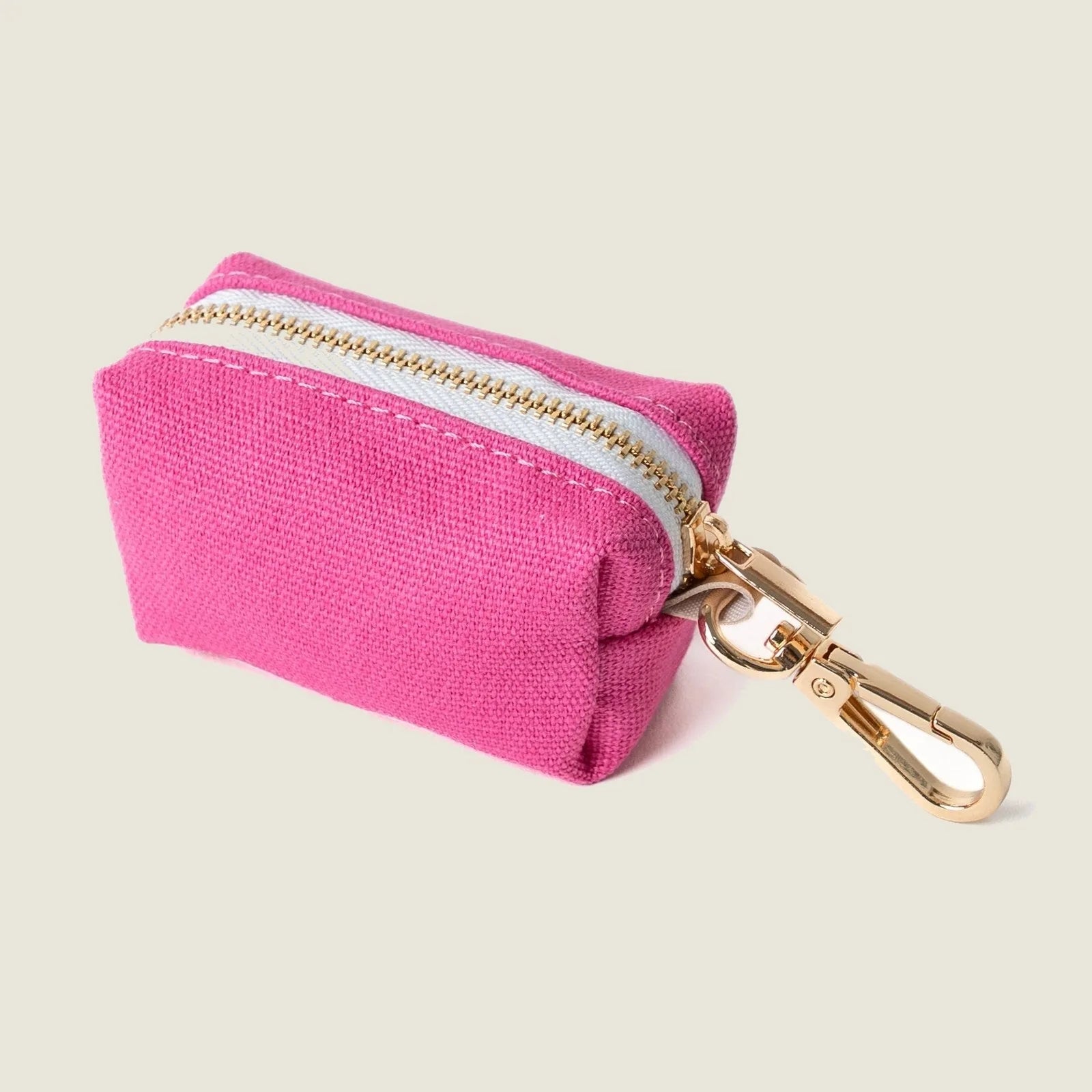 Magenta poop bag holder by FURLOU with a gold clip and zip closure, perfect for dog walking essentials.