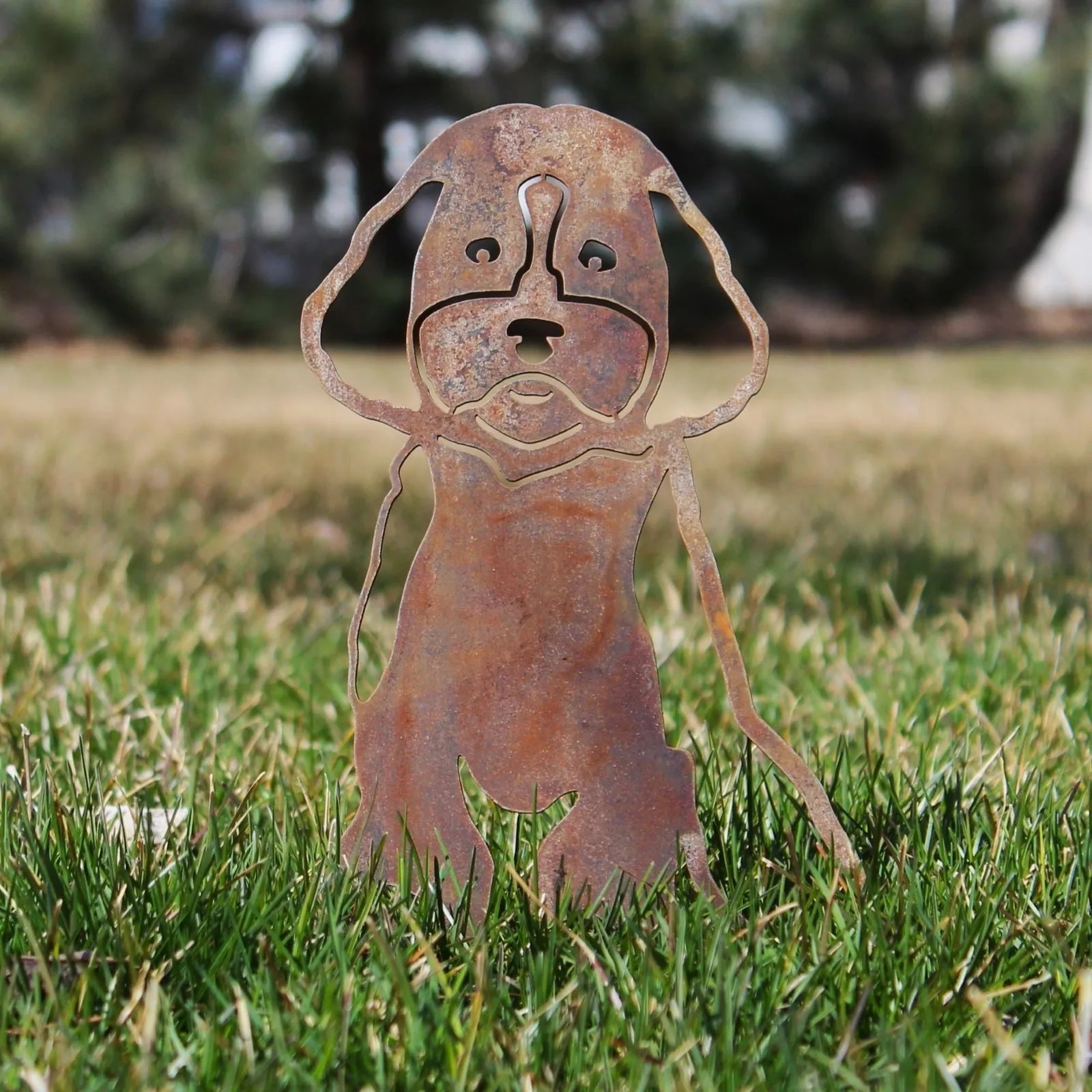 Rusty Corten steel Maltipoo silhouette standing on grass, showcasing intricate cut-out design for outdoor dog decor.