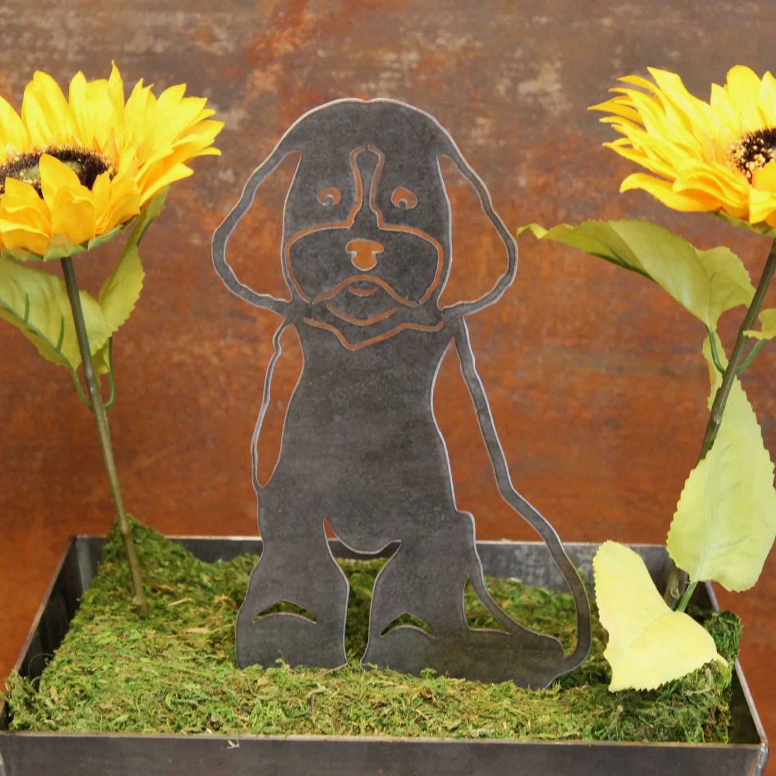 Maltipoo metal silhouette in black against a rustic background with sunflowers and greenery. Perfect outdoor dog decor.