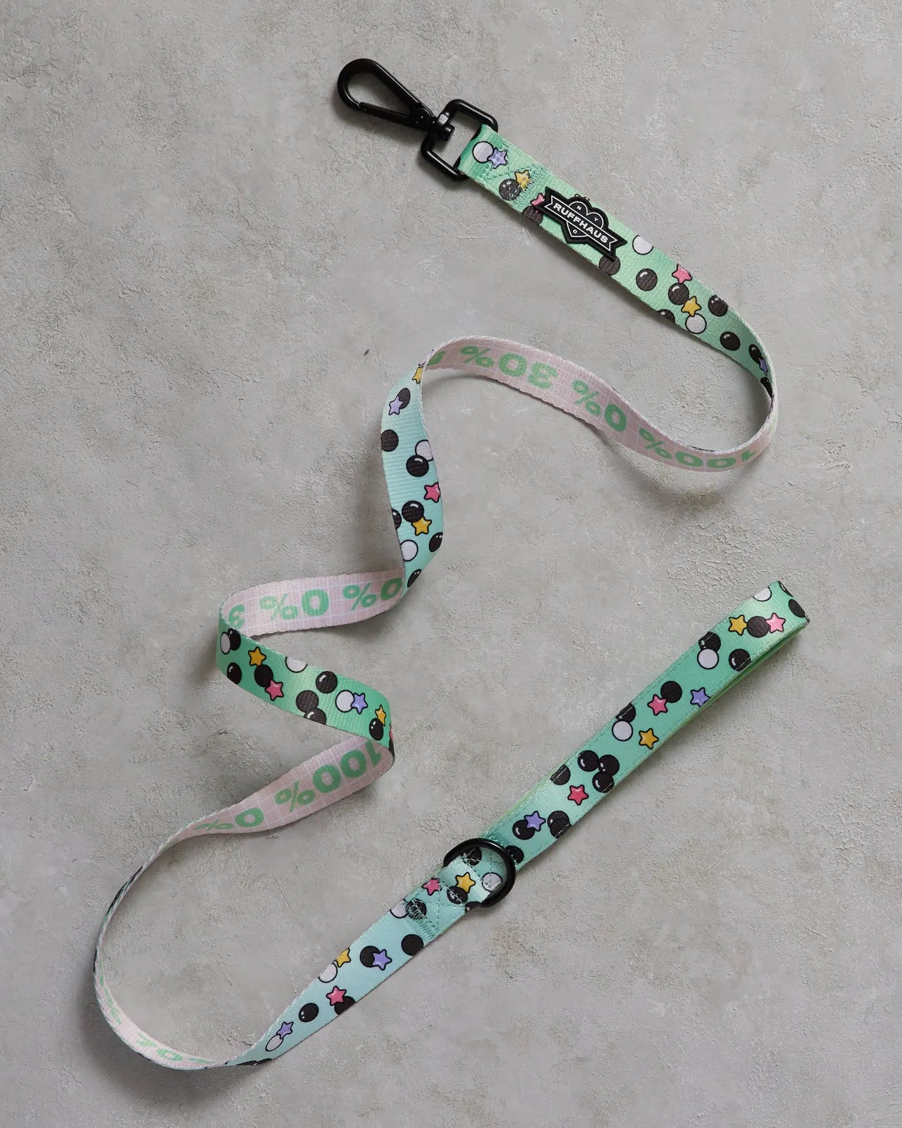 Matcha green dog leash featuring playful black and colorful star patterns, made of durable polyester with a neoprene grip.