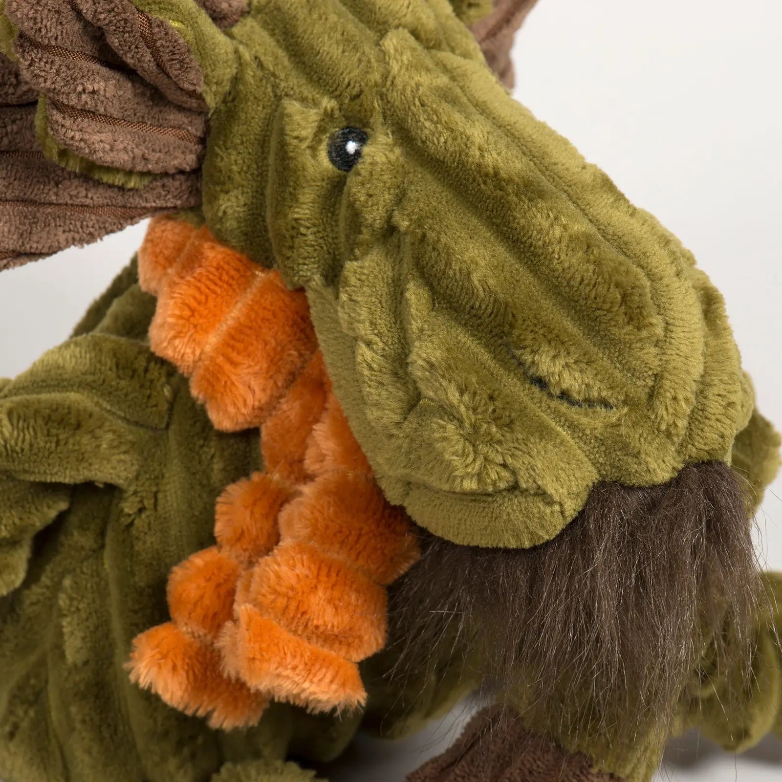 Cuddly Milo Moose plush dog toy in green and orange corduroy, featuring knotted limbs and a soft, textured design.
