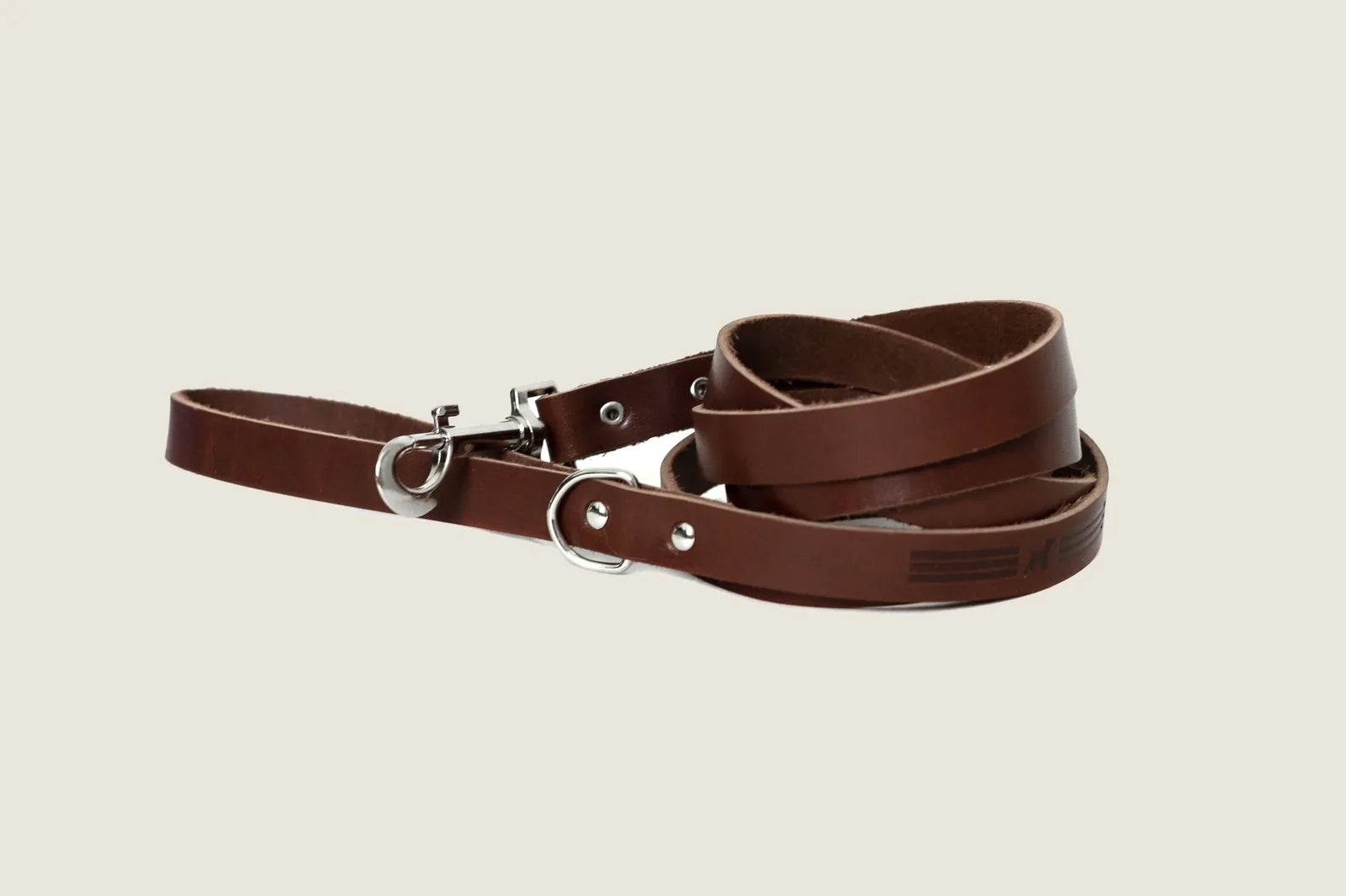 Chocolate leather dog leash with a sleek design, featuring a silver clip and D-ring for added functionality.