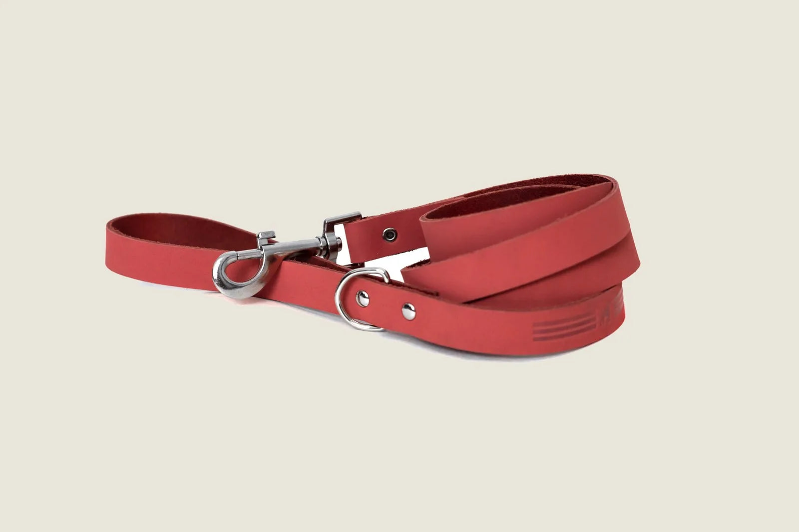 Coral reef leather dog leash with sleek design, featuring a silver clip and extra d-ring near the handle.