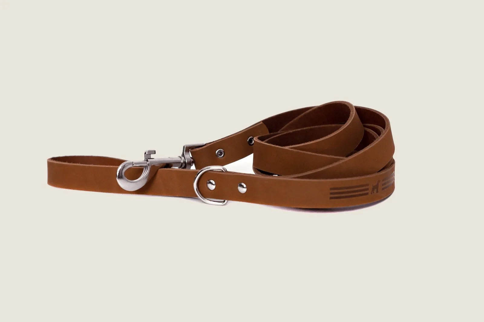 Earth brown leather dog leash with a sleek design, featuring a metal clasp and extra d-ring for convenience.