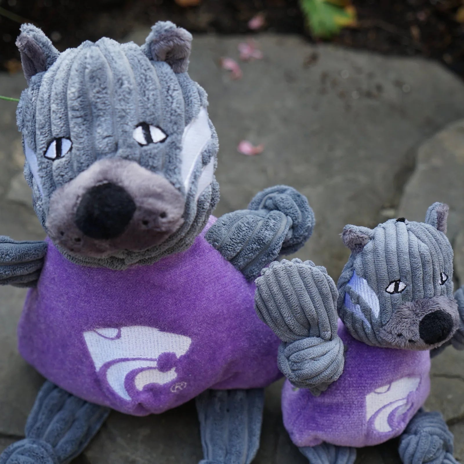 Gray plush Willie the Wildcat plush dog toy in purple fabric, featuring knotted limbs and a friendly design.