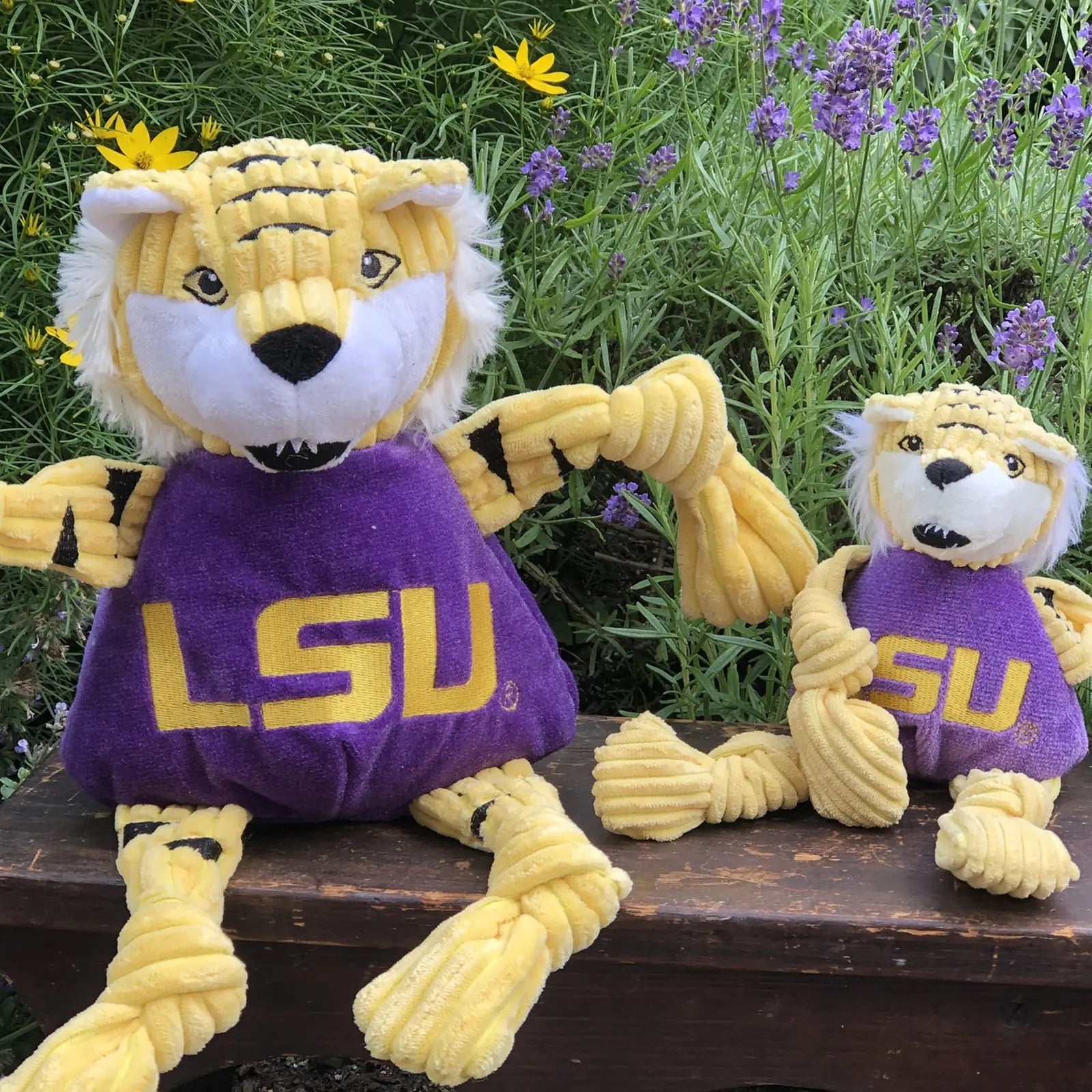 Plush LSU Mike the Tiger Knottie® toys in yellow and purple, featuring knotted limbs and playful expressions.