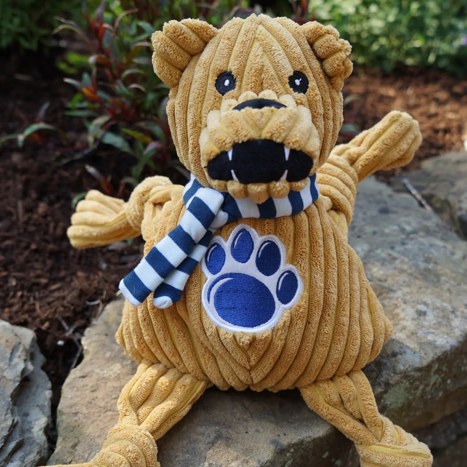 Nittany Lion Knottie® plush dog toy in Penn State colors, featuring knotted limbs, striped scarf, and embroidered paw print.