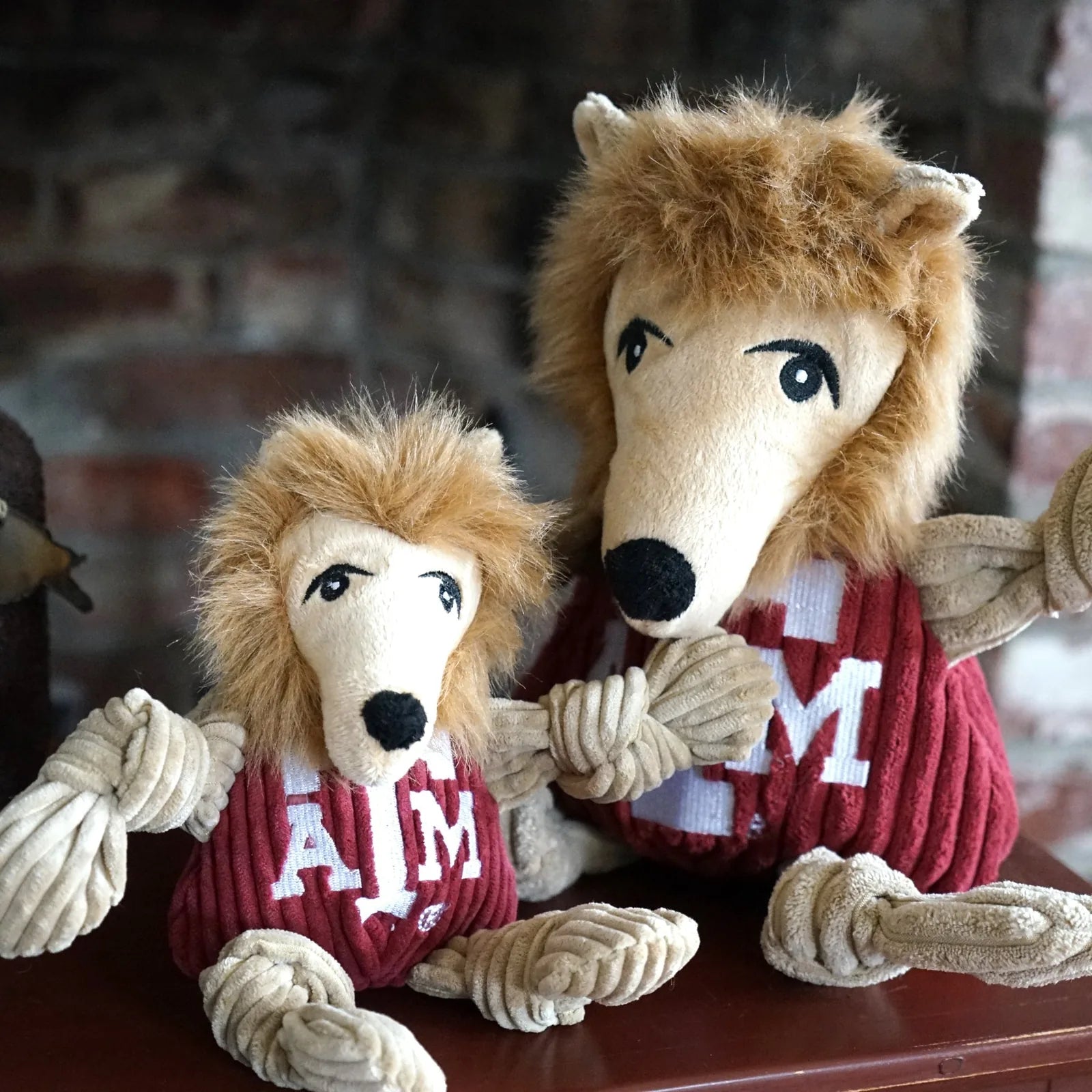 Texas A&M Reveille Knottie® plush dog toys in maroon and cream, featuring knotted limbs and playful expressions.