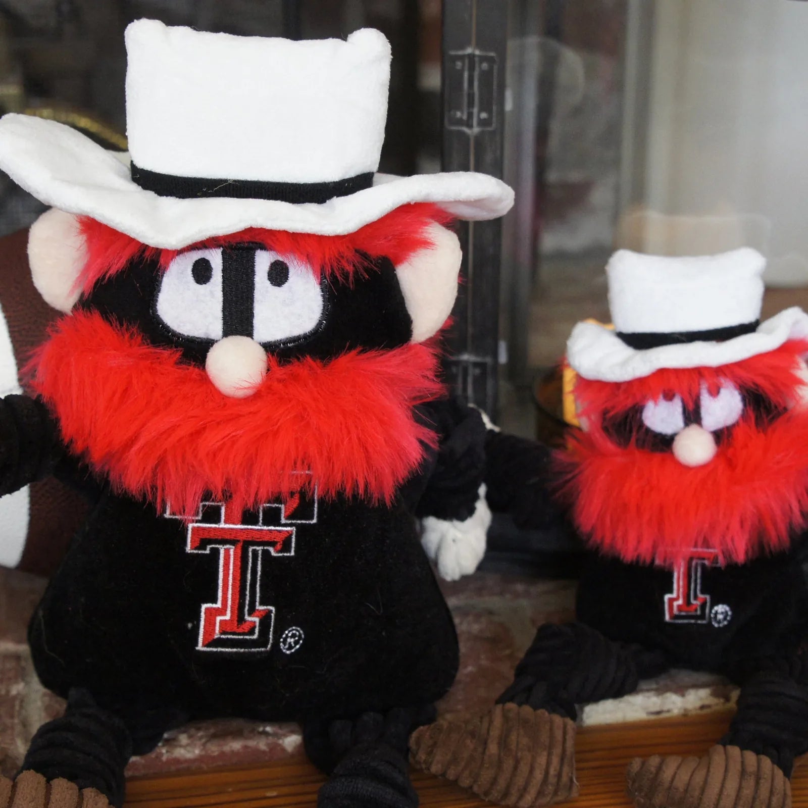 Texas Tech Raider Red plush dog toy featuring knotted limbs, plush fabric, and vibrant red beard, ideal for playful tugging.
