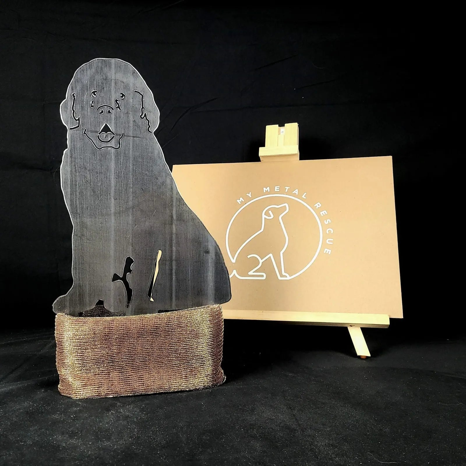 Handcrafted Newfoundland dog silhouette in weathered steel, featuring a rustic finish with metal stakes for garden display.