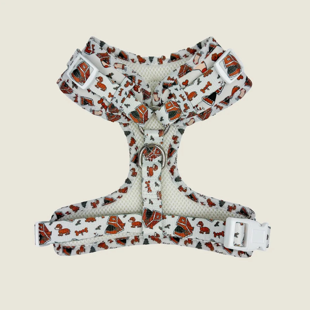 Adjustable harness with a fun red and orange dog pattern, featuring breathable mesh and plastic buckles for comfort and fit.