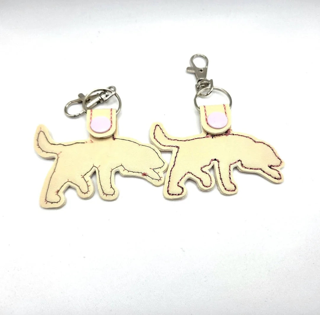 Embroidered Labrador Retriever keychain tab in cream color with a swivel clip and pink snap detail.