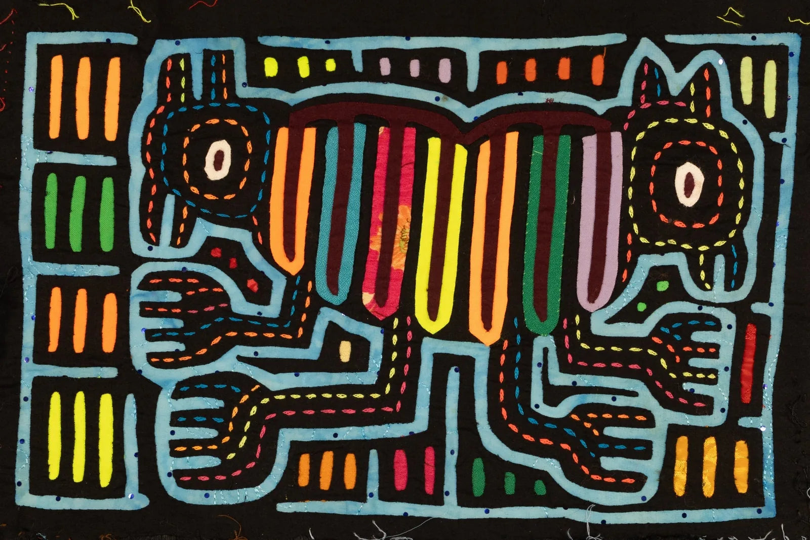 Hand-stitched Panama Mola showcasing an optical illusion design with two colorful dogs against a black background.