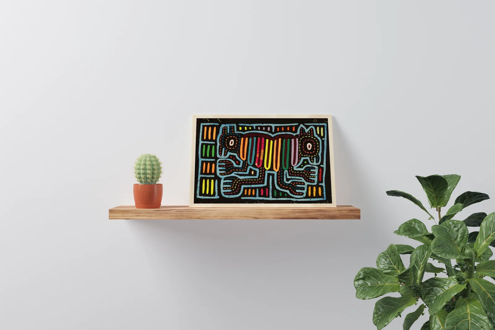 Hand-stitched Mola tapestry showcasing two colorful dogs on a black background, displayed on a wooden shelf.