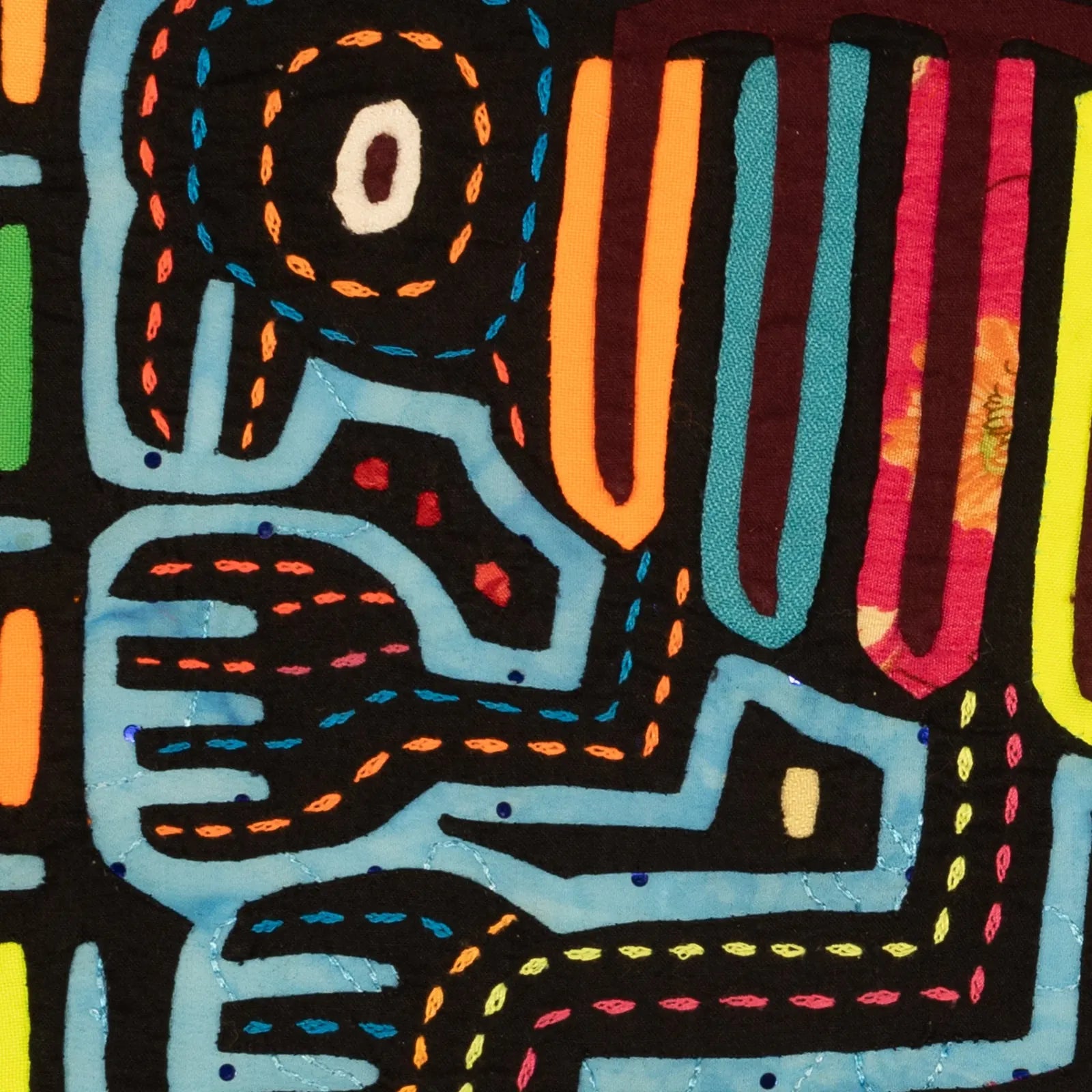 Colorful optical illusion design featuring abstract dog shapes in hand-stitched textile art by Guna artisans.