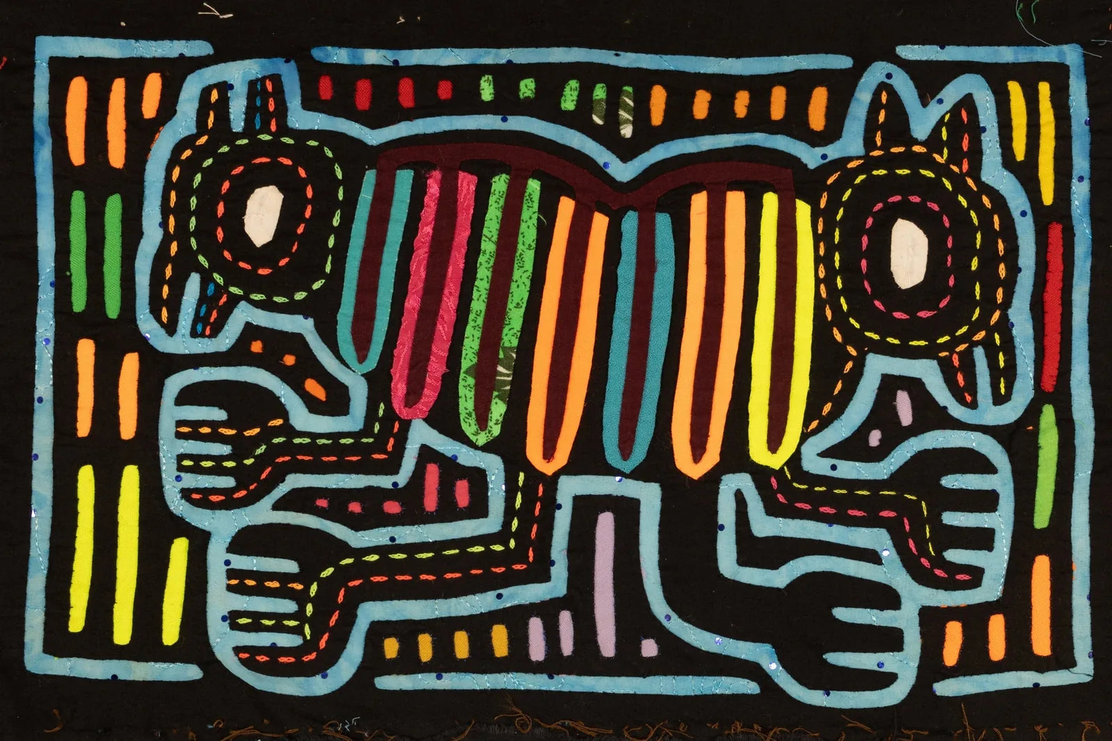 Colorful hand-stitched Panama Mola featuring a dog design with vibrant stripes against a black background.