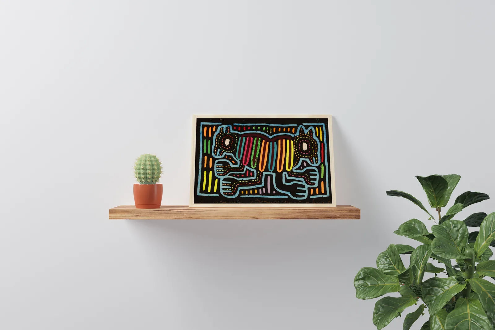 Vibrant hand-stitched Mola tapestry featuring two dogs on a black background, displayed on a wooden shelf with plants.