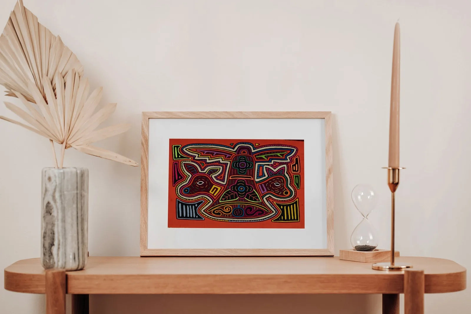 Colorful orange and white puppy dog tapestry, hand-stitched in a framed design with intricate patterns.