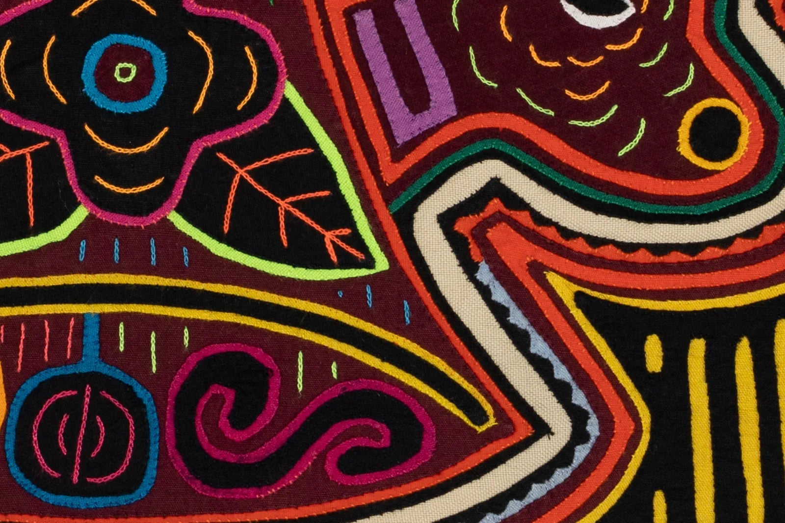 Colorful hand-stitched textile featuring vibrant orange and white puppy dog design in layered appliqué style.