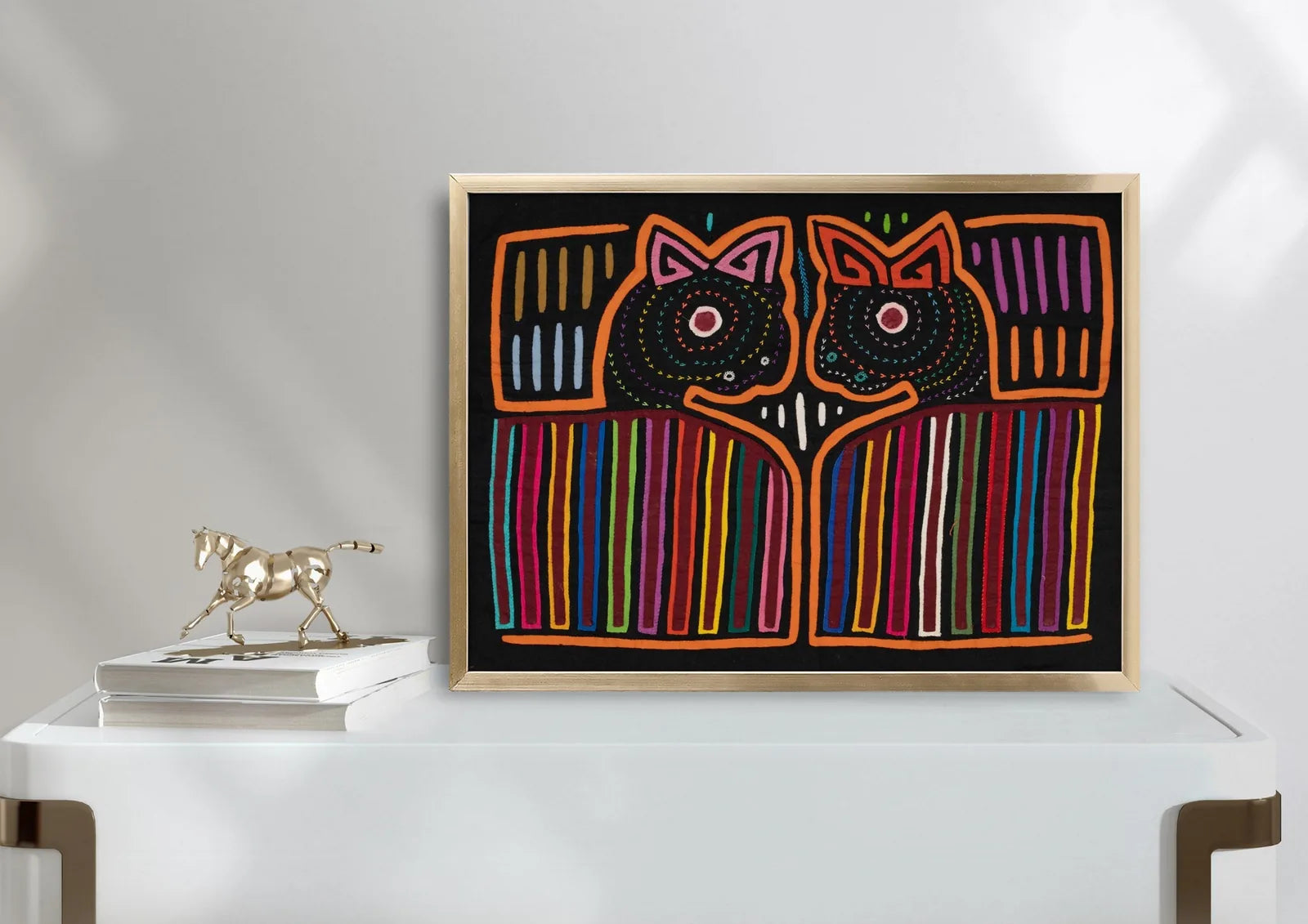 Hand-stitched orange puppy dog mola tapestry with colorful geometric patterns on a black background.