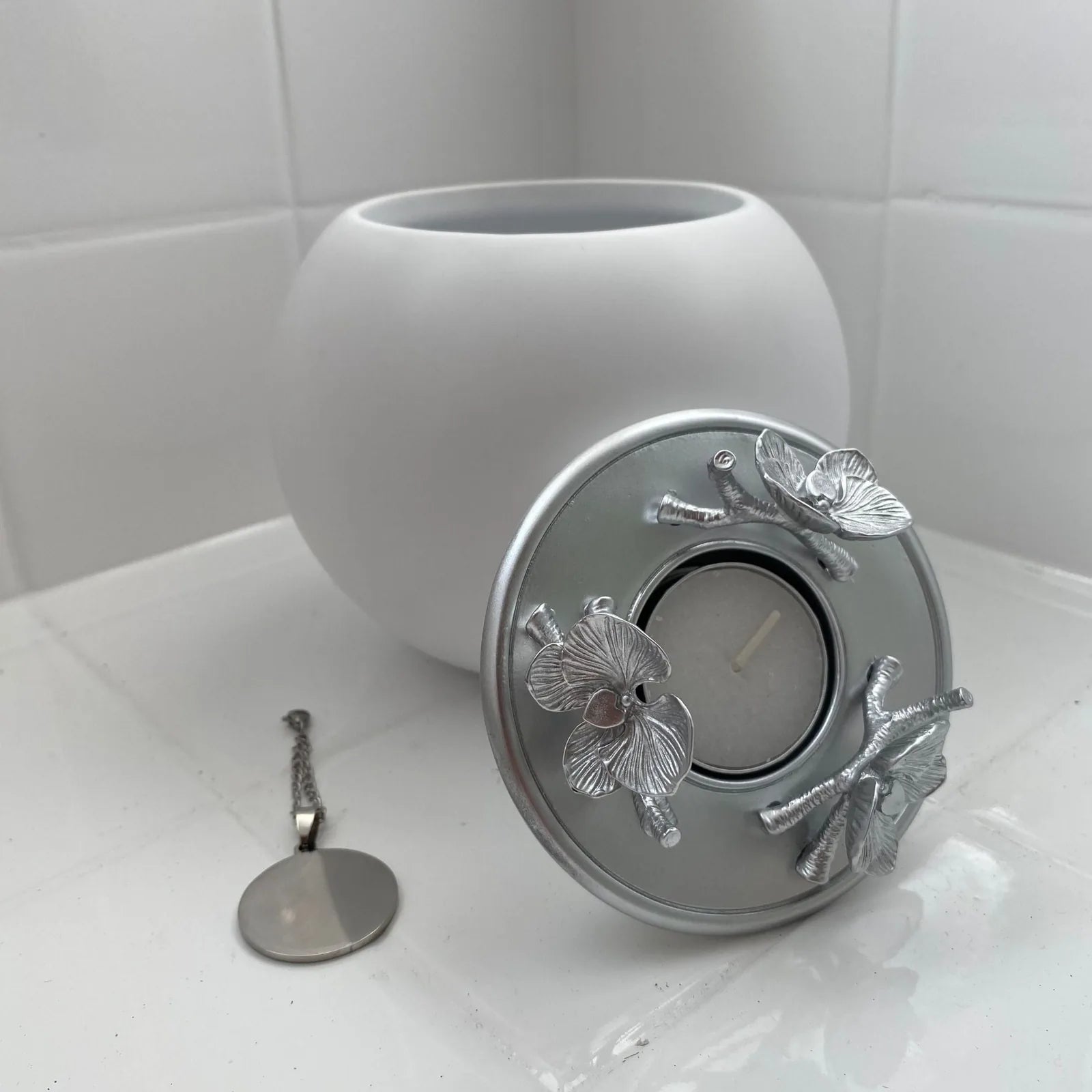 Handmade white orchid urn with elegant silver floral lid, perfect for honoring your pet's memory.
