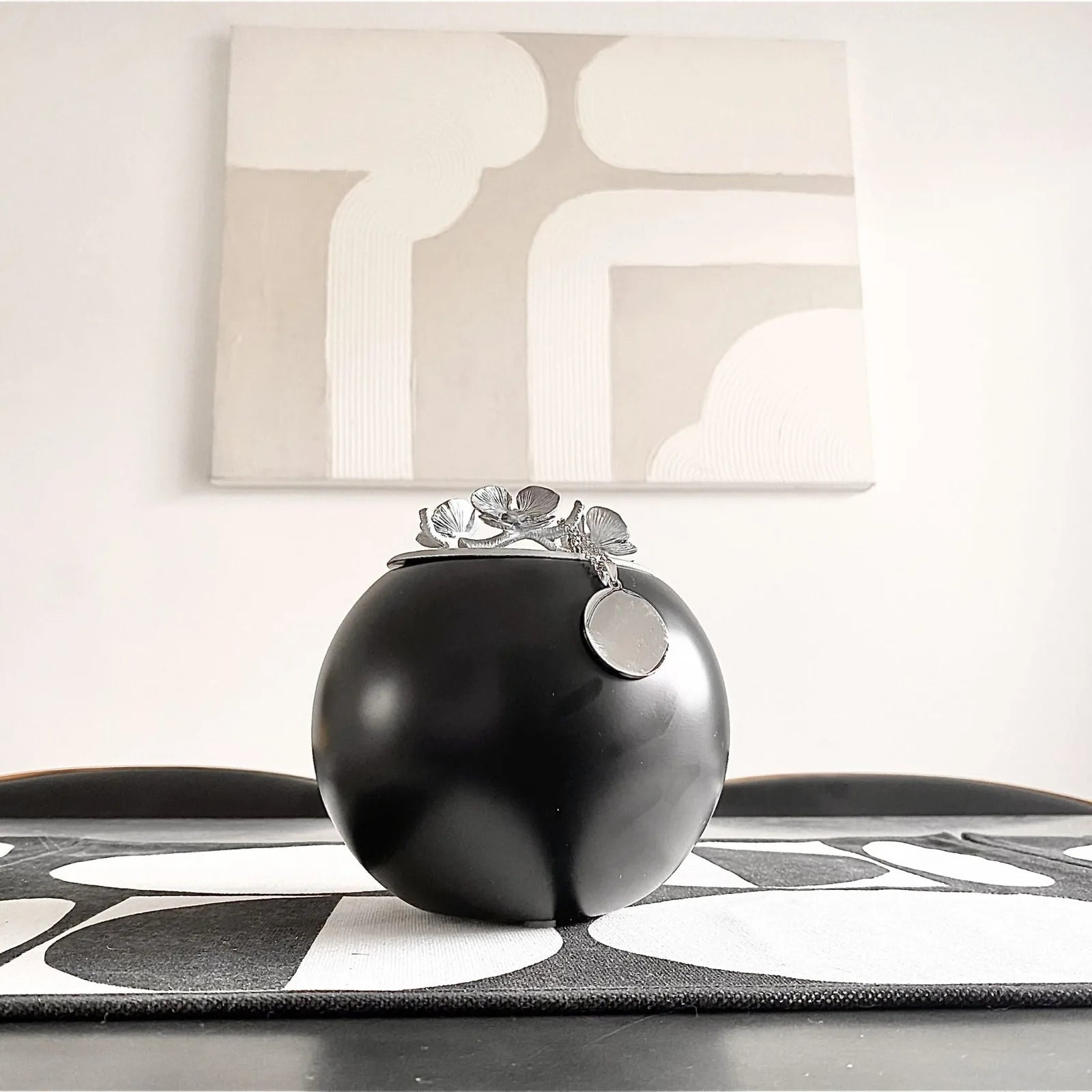 Handmade black Orchid Urn from GNight Fetcher, featuring a silver leaf design and a circular tag on top.