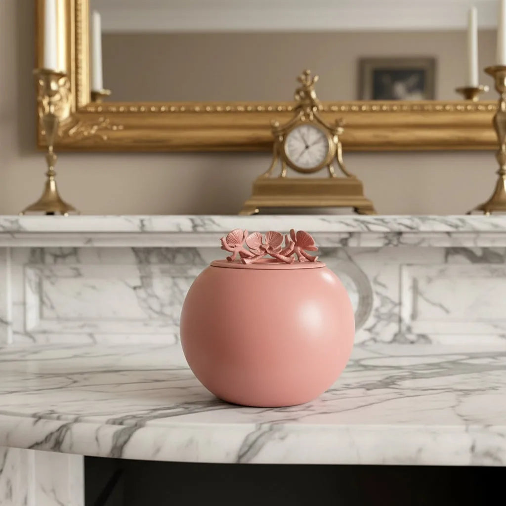 Coral Orchid Urn with floral lid resting on a marble countertop, honoring beloved pets with elegance and warmth.