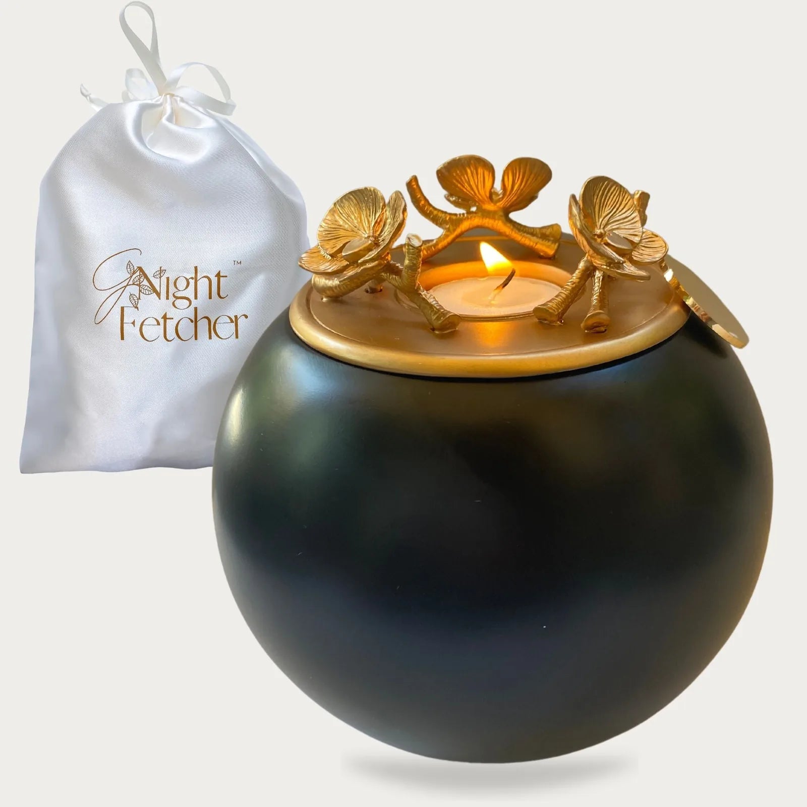 Handmade black orchid urn with a gold floral lid, accompanied by a white satin GNight Fetcher pouch.