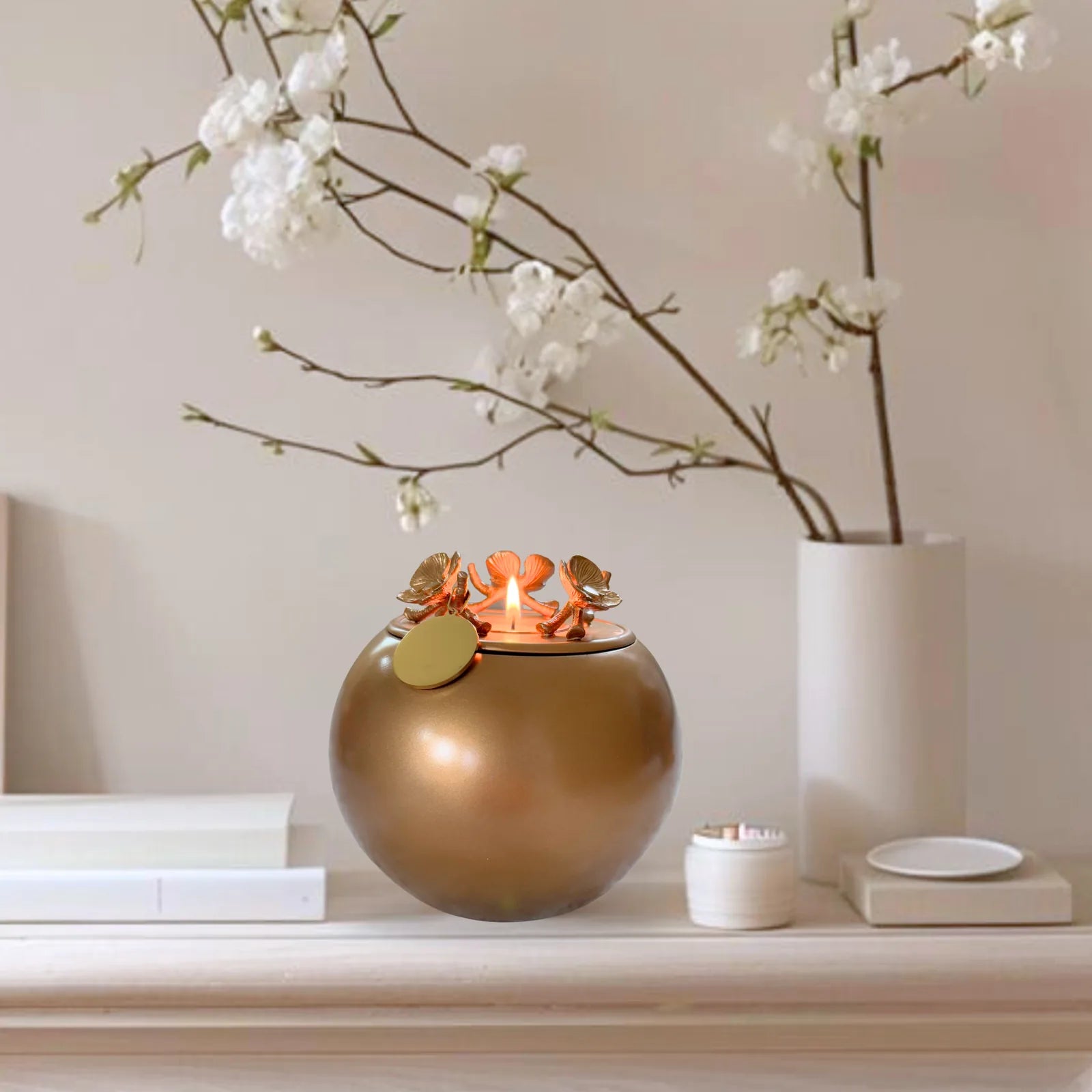 Handcrafted gold Orchid Urn with decorative flower details, elegantly displayed on a shelf among minimal decor.