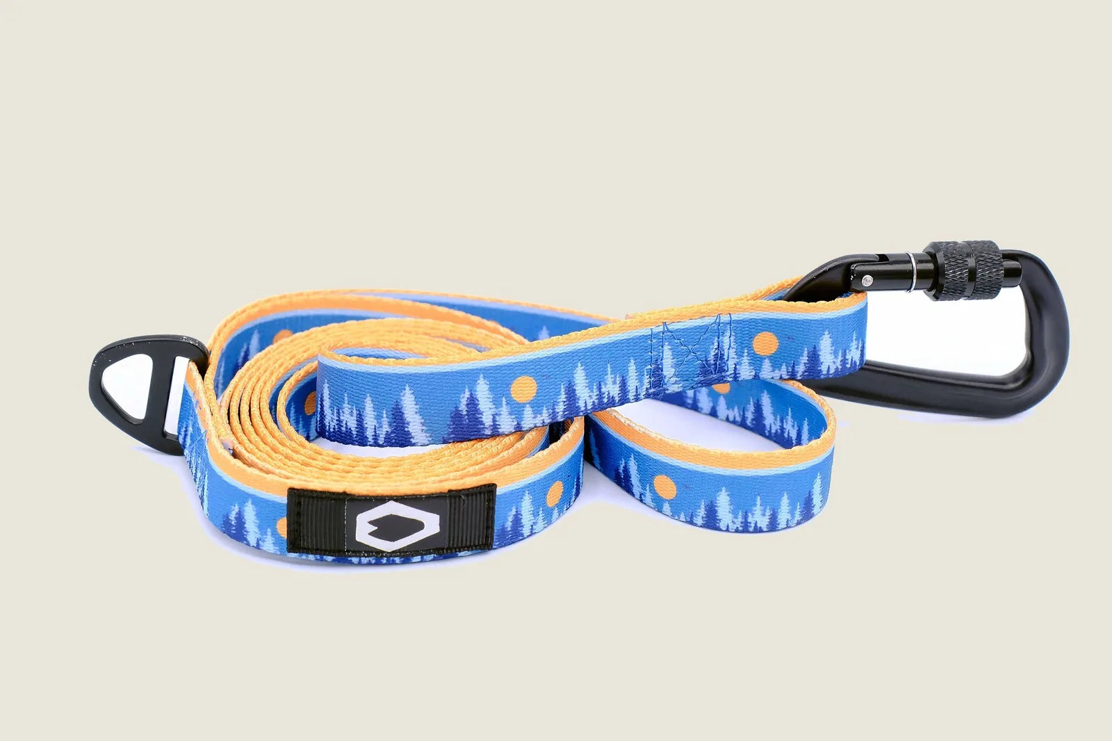 Blue and yellow nylon dog leash featuring tree pattern and black aluminum carabiner for secure attachment.