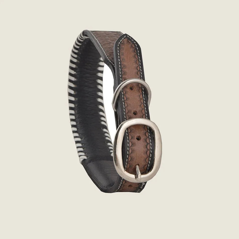 Stylish hand-tooled leather dog collar featuring a floral pattern, adjustable with a silver buckle and contrasting stitching.
