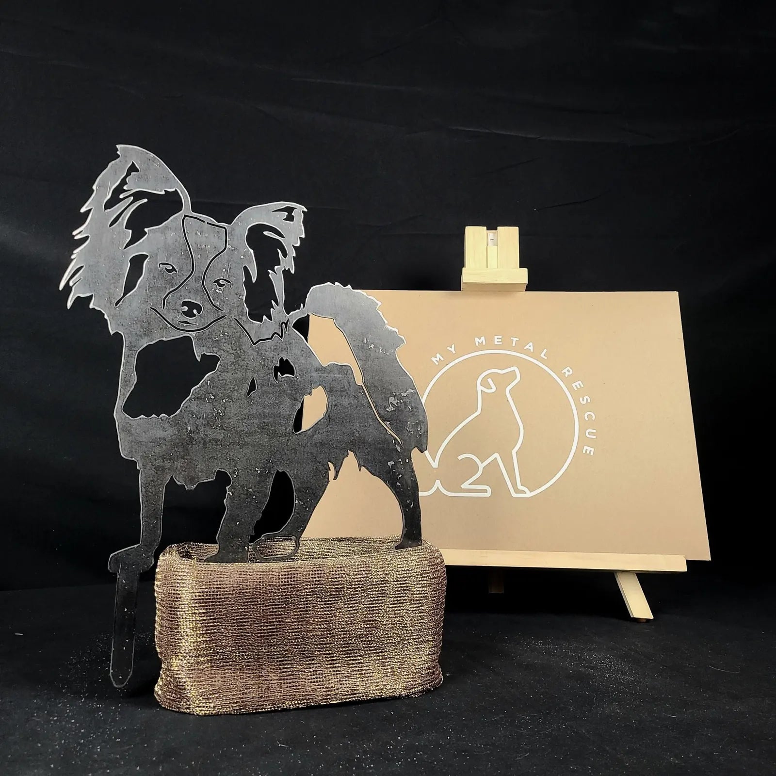 Handcrafted Papillon dog silhouette in black metal, displayed on a textured base, next to a My Metal Rescue card.