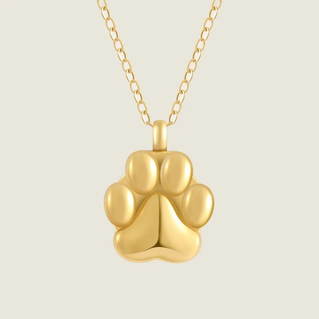 Rose gold paw print cremation necklace on a delicate chain, designed to hold pet ashes and honor cherished memories.