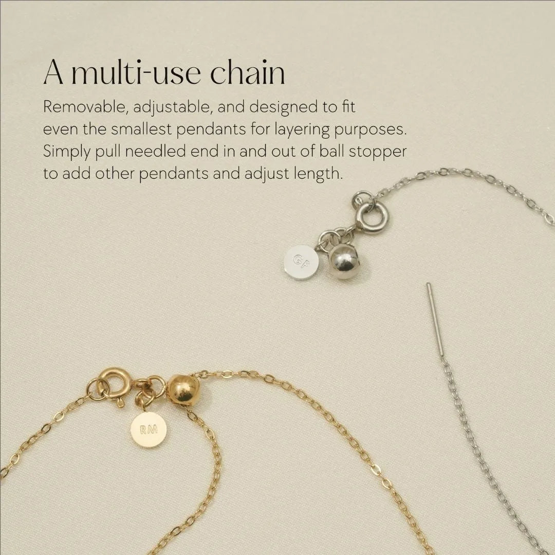 Adjustable gold and silver chains designed for layering small pendants, featuring ball stoppers and engraved tags.