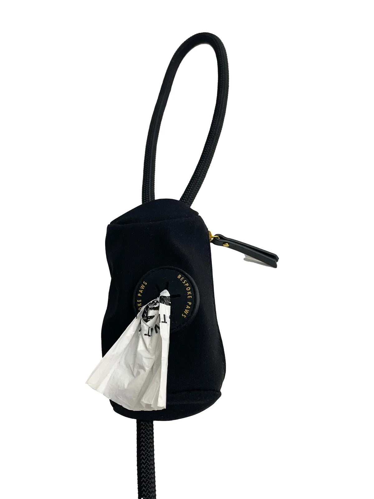 Sleek black waste bag dispenser with a loop, showcasing a white waste bag peeking out. Stylish and functional design.