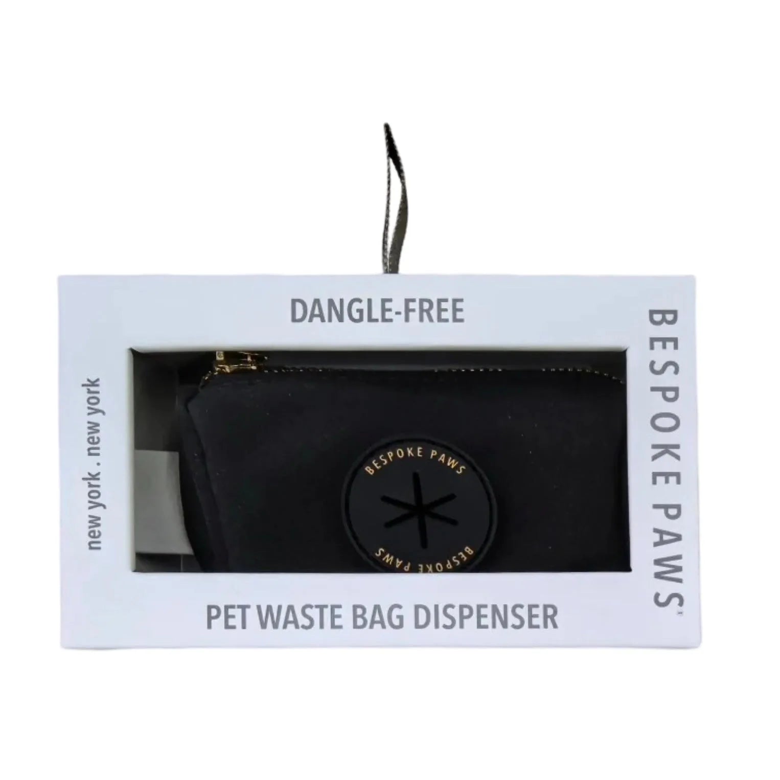 Sleek black waste bag dispenser with gold accents in packaging labeled "DANGLE-FREE" by BESPOKE PAWS.