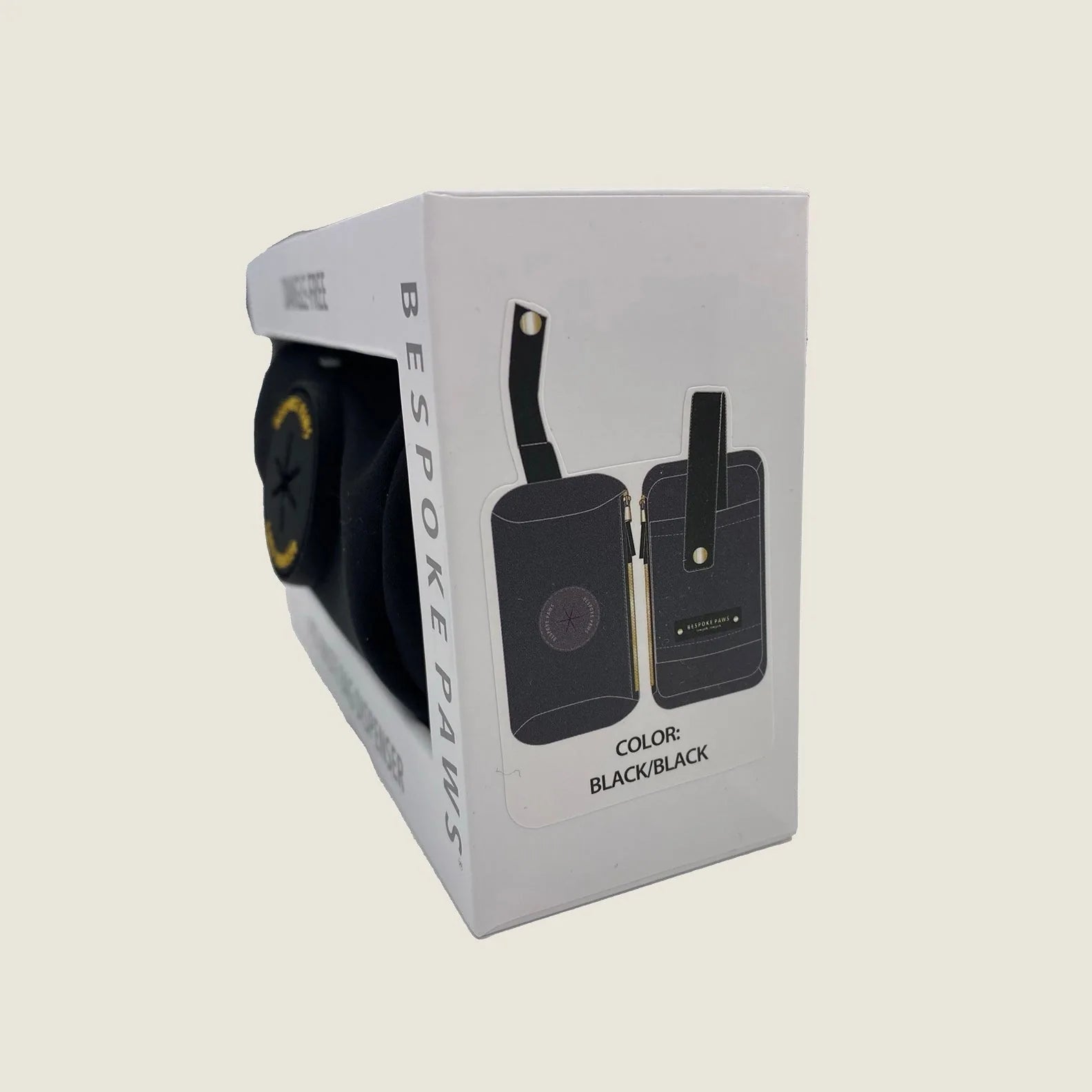 Black Pawsh Pouch waste bag dispenser displayed in packaging, showcasing its sleek design and dangle-free feature.