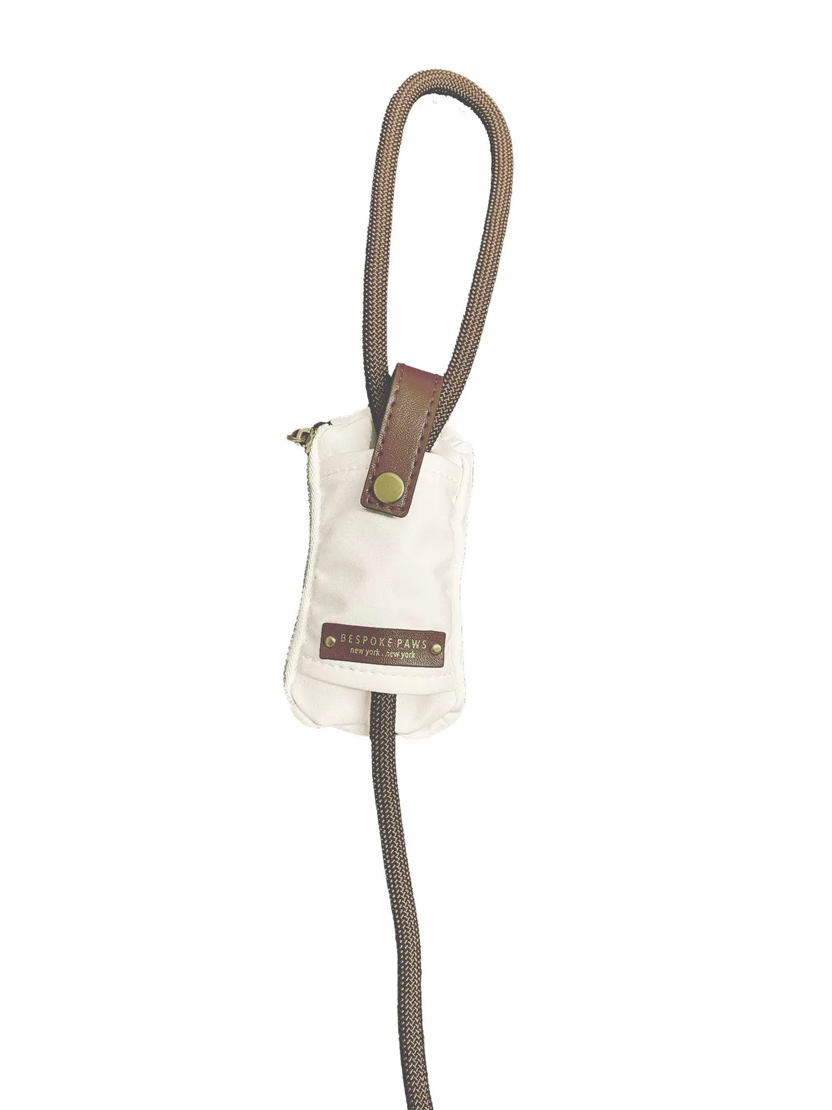 Ivory waste bag dispenser with brown vegan leather accents and a dangle-free design, featuring a small zipper and strap.