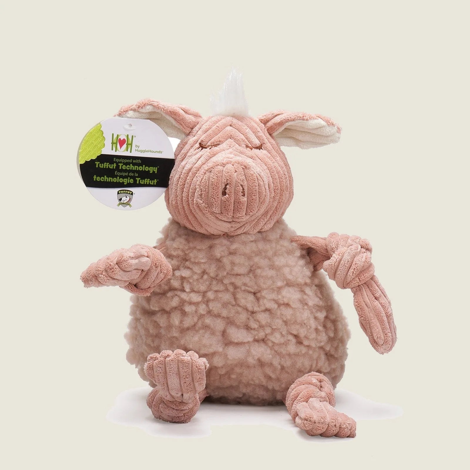 Soft pink plush Penelope Pig toy with knotted limbs, fluffy body, and a cute face, designed for durable dog play.