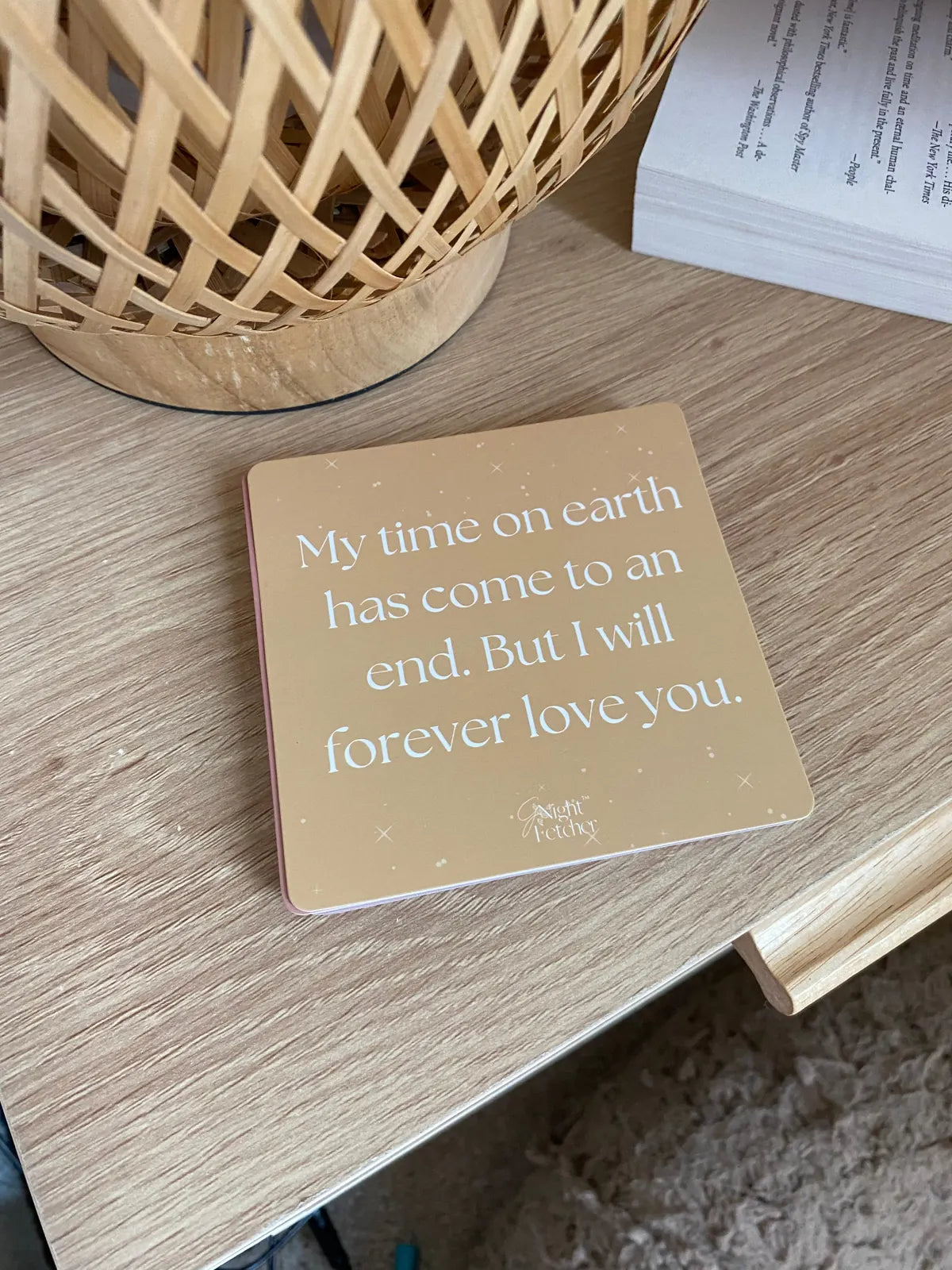 Sympathy card on a wooden table, featuring the message: "My time on earth has come to an end. But I will forever love you."