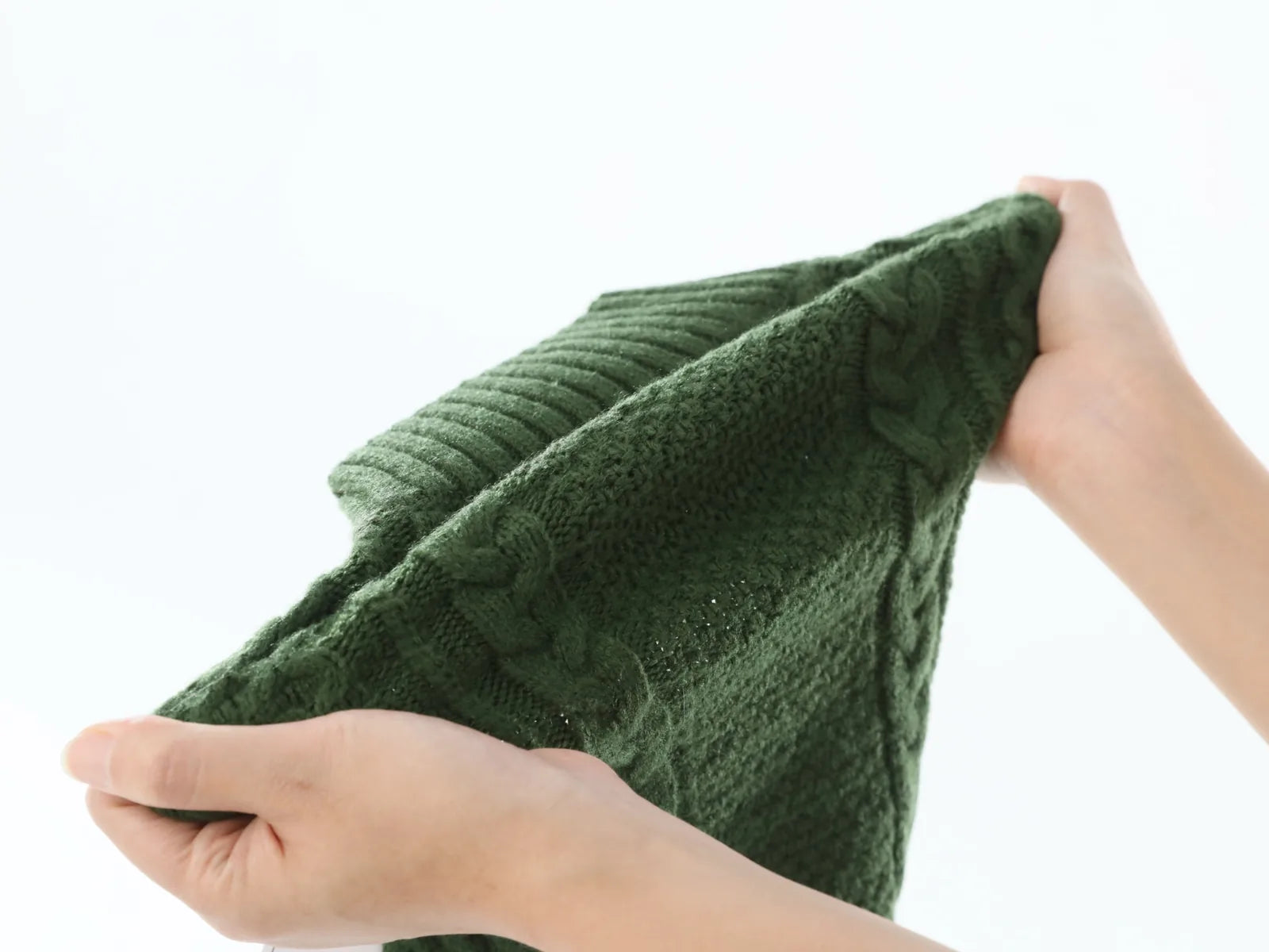 Cozy green knit pet sweater vest with textured patterns, perfect for keeping dogs warm on cooler days.