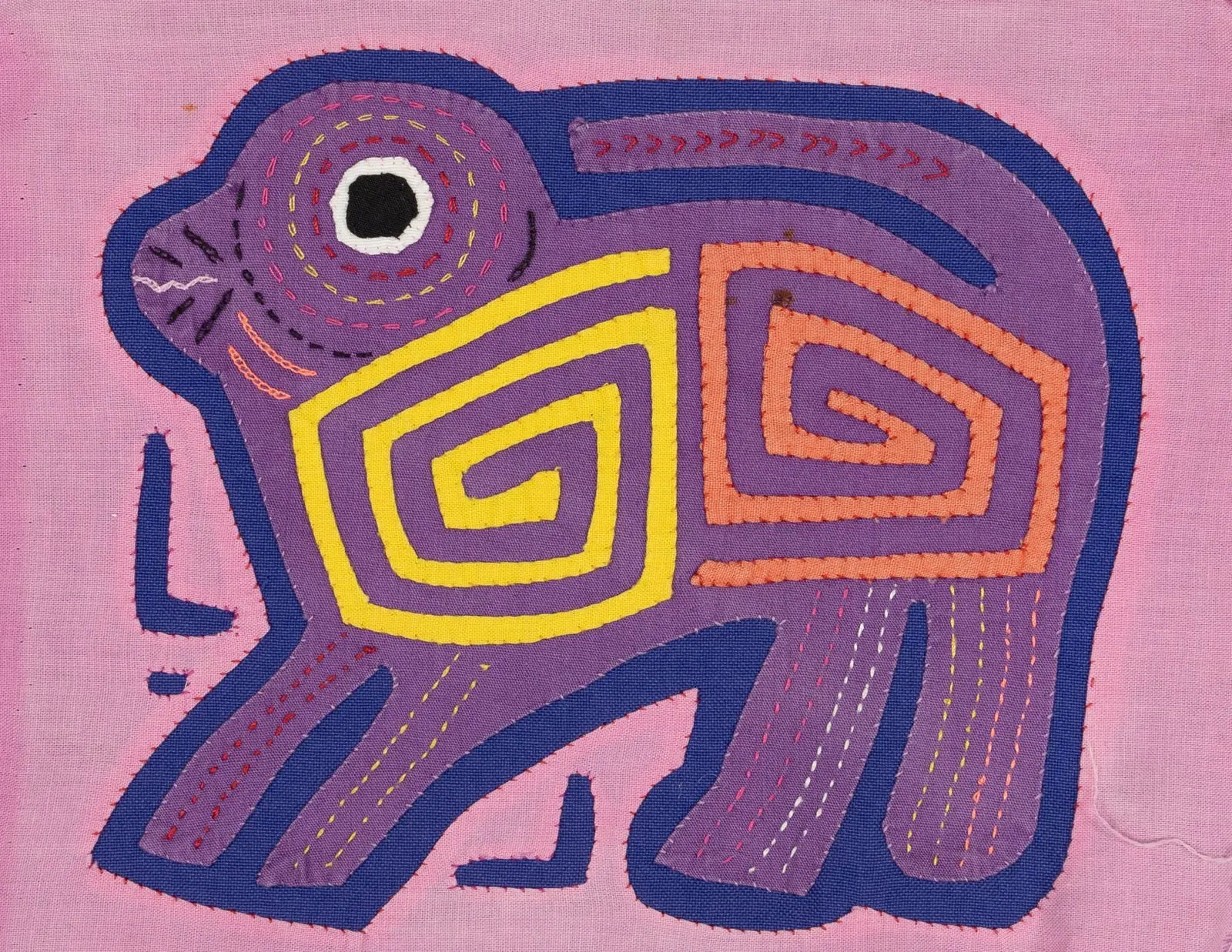 Hand-stitched purple and pink Mola depicting a playful puppy with geometric designs on a pink background.